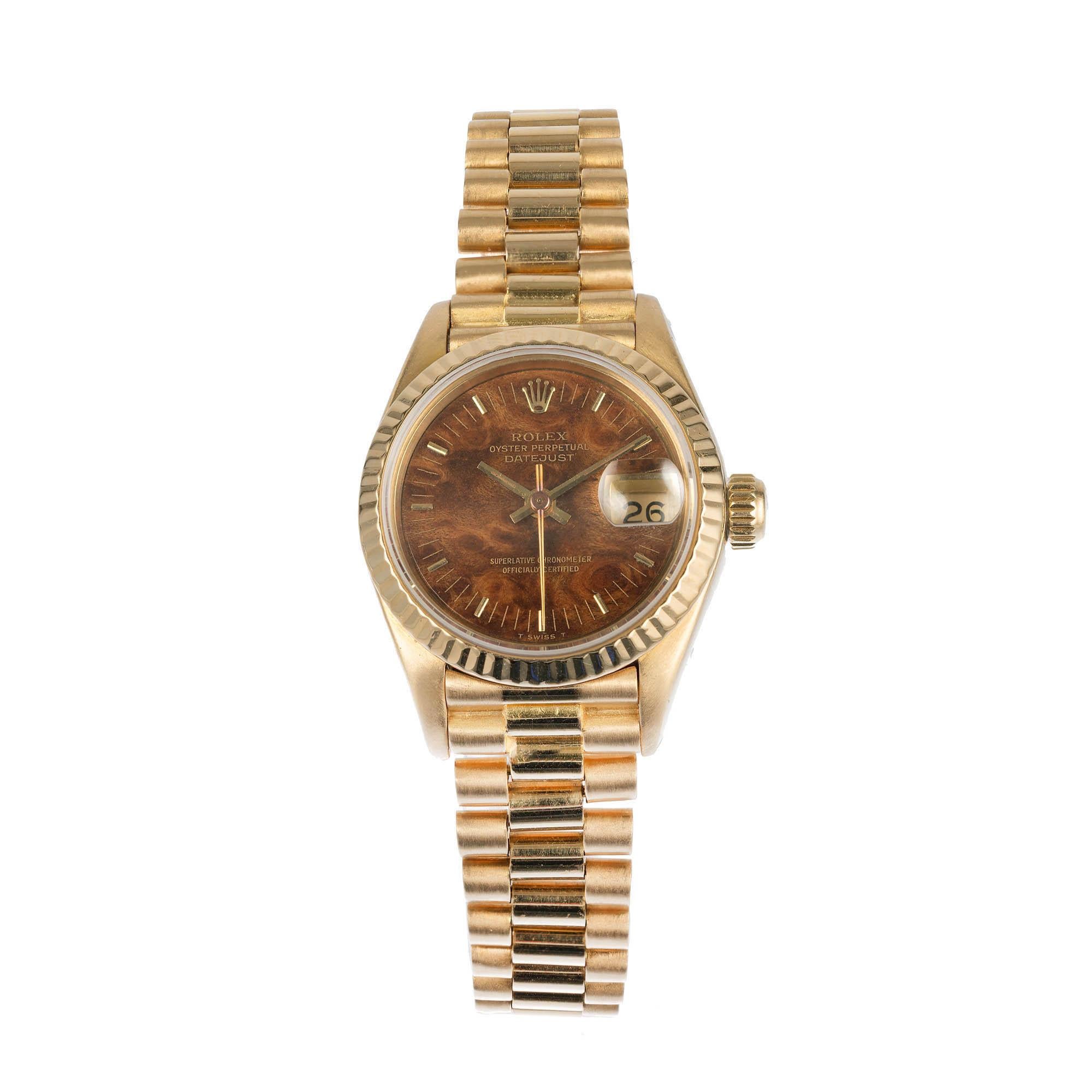  Ladies Rolex President 18k yellow gold wrist watch made in 1984. Fully serviced.  Original Rolex Wood Dial. 

18k yellow gold 
67.2 grams 
Length: 6 3/8 inches 
18k yellow gold 
Length: 32.84mm 
Width: 26mm 
Band width at case: 13mm 
Case