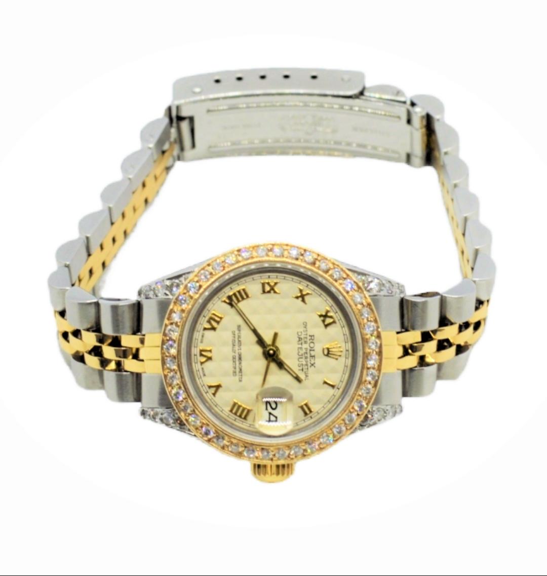 (Watch Description) 
Brand - Rolex
Gender - Ladies 
Model - 69173 Datejust
Metals - Yellow Solid Gold
Case size - 26mm
Bezel - Yellow gold Diamond
Crystal - Sapphire
Movement - Automatic Cal.2135
Dial - Pyramod Roman 
Wrist band - Yellow solid