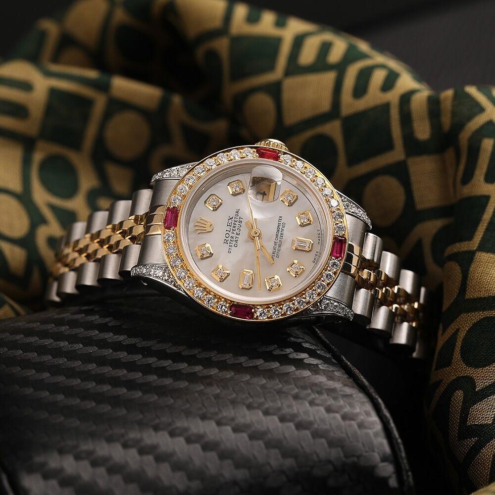 Ladies Rolex 26mm Datejust Two Tone Jubilee White MOP Mother Of Pearl 8 + 2 Diamond Accent Bezel + Lugs + Rubies 69173.
This watch is in like new condition. It has been polished, serviced, and has no visible scratches or blemishes. All our watches
