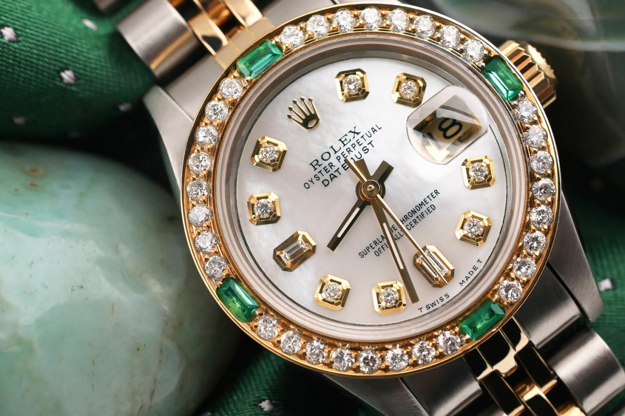 Rolex Datejust 26mm Custom White MOP Diamond Dial 8+2, Diamond/Emerald Bezel. Two Tone Watch with Jubilee Band 69173.

This watch is in like new condition. It has been polished, serviced and has no visible scratches or blemishes. All our watches