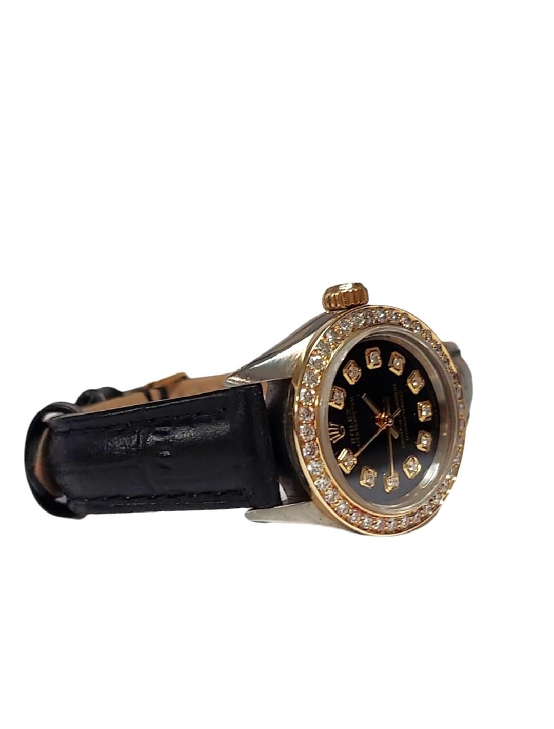 Rolex oyster perpetual 
Gender - ladies 
Case size - 26mm
Metals - steel / Yellow gold
Model - 6724
Bezel- custom Yellow gold 1.0CT Diamond 
Dial - custom Black diamond 
Movement- automatic caliber 2030
Crystal - sapphire 
Band - generic black