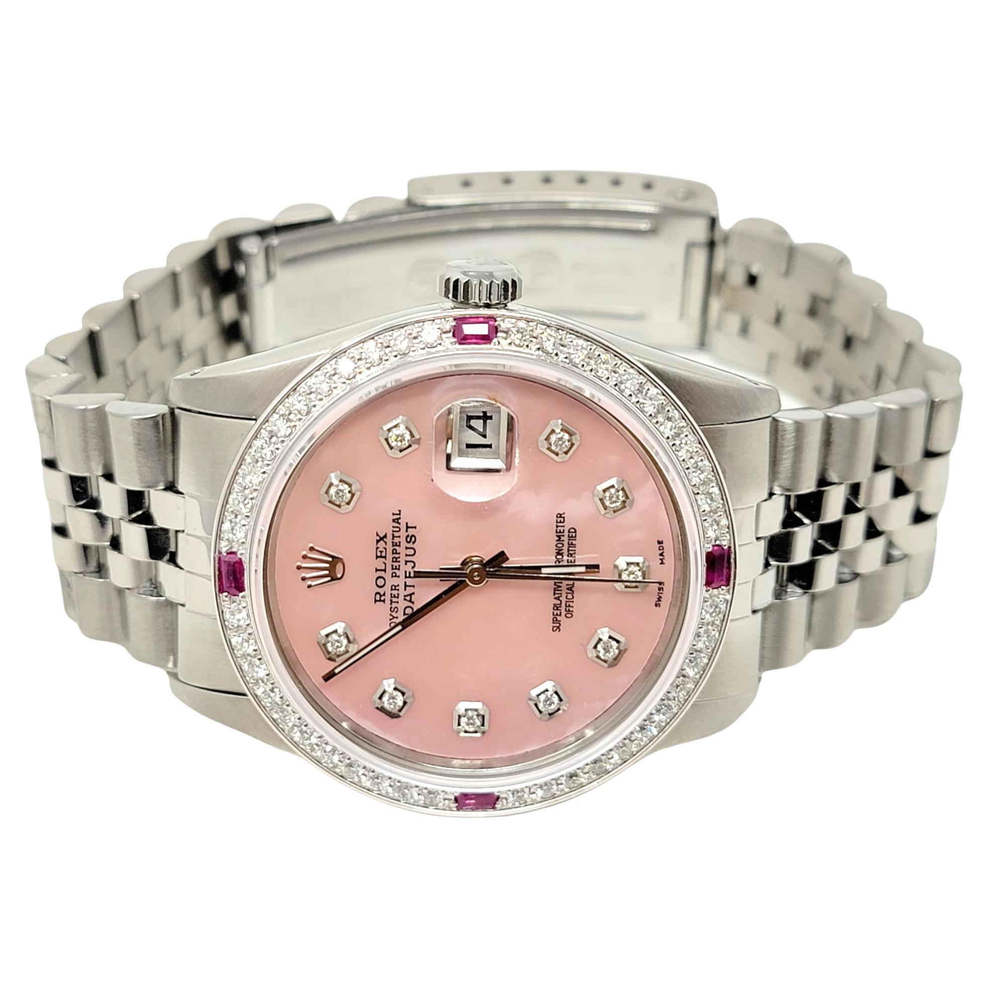 Incredible ladies custom pink Mother of Pearl Rolex datejust wristwatch. This stunning, high quality designer timepiece is embellished with shimmering natural diamonds and rubies and is made of 18 karat white gold and stainless steel. This