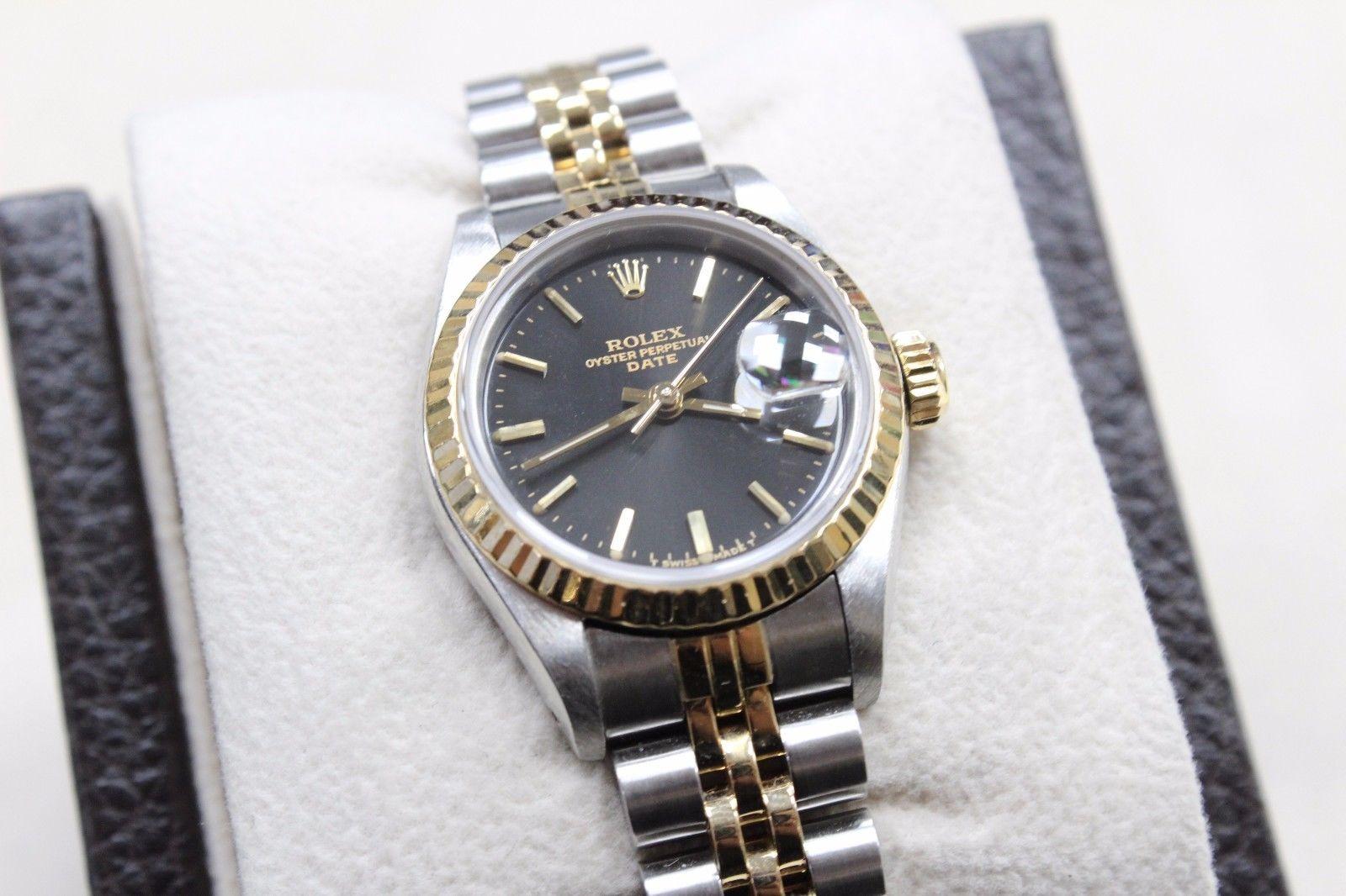 Style Number: 69173

Model: Date

Case Material: Stainless Steel 

Band: 18K Yellow Gold & Stainless Steel 

Bezel: 18K Yellow Gold

Dial: Black

Face: Sapphire Crystal 

Case Size: 26mm

Includes: 

-Rolex Watch Box & Papers

-Certified Appraisal