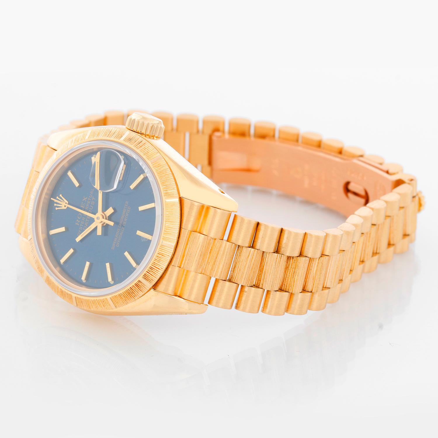 Rolex Ladies Bark President Gold Watch 69278 - Automatic winding, 29 jewels, Quickset, sapphire crystal. 18k yellow gold with bark bezel (26 mm). Blue dial with stick hour markers . 18k yellow gold hidden-clasp President bracelet with barked center