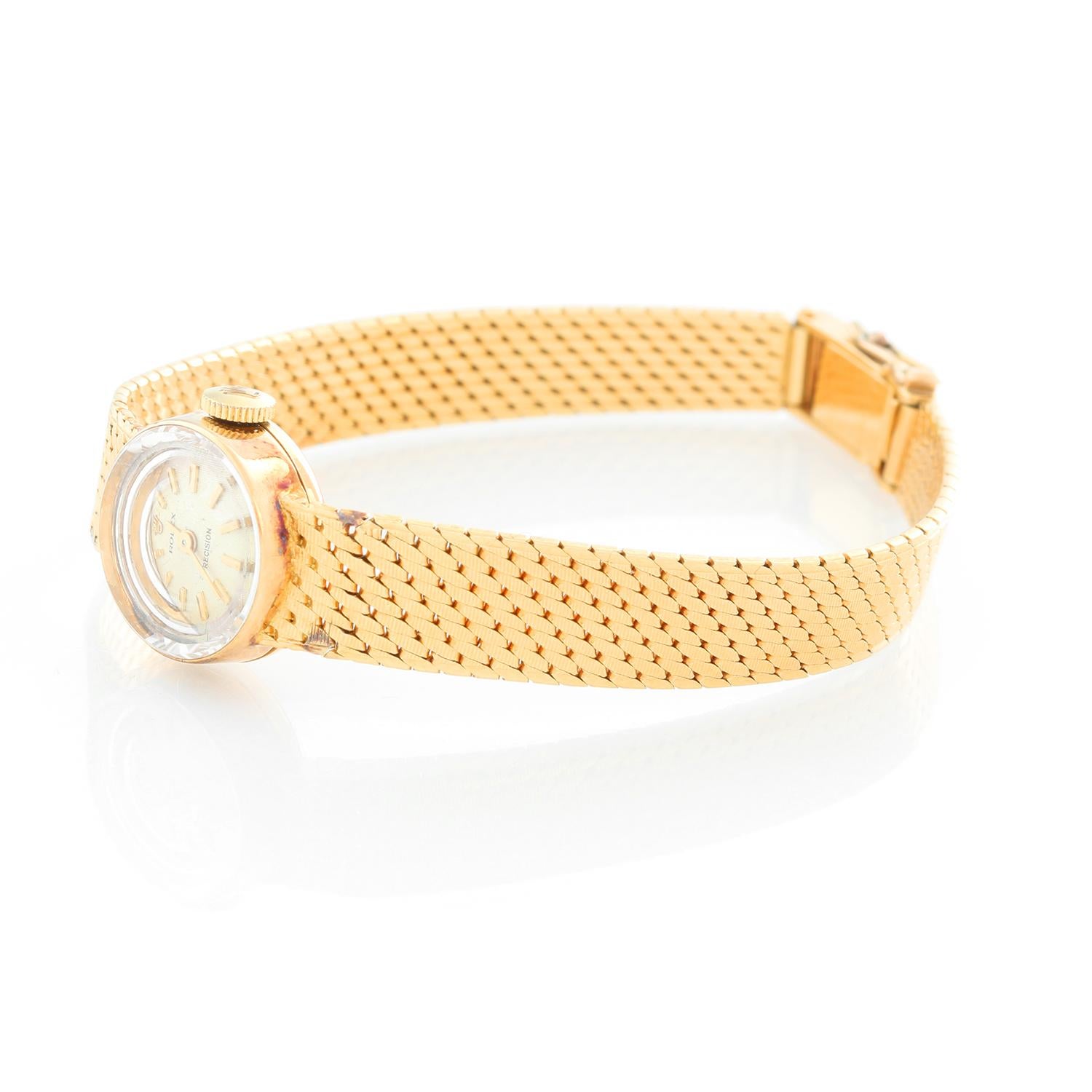 Rolex Ladies Classic 18K Yellow Gold Watch - Manual winding. 18K Yellow gold (15 mm). Silver textured stick dial. 18K Yellow gold bracelet with hinged clasp; will fit up to a 6 inch wrist. Pre-owned with custom box .
