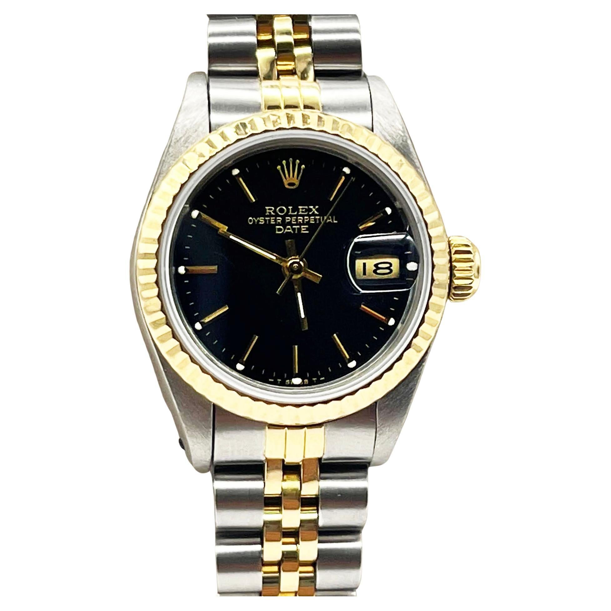 Style Number: 69173

Serial: R841***

Year: 1990

Model: Date

Case Material: Stainless Steel 

Band: 18K Yellow Gold & Stainless Steel 

Bezel: 18K Yellow Gold

Dial: Black

Face: Sapphire Crystal 

Case Size: 26mm 

Includes: 

-Rolex Box &