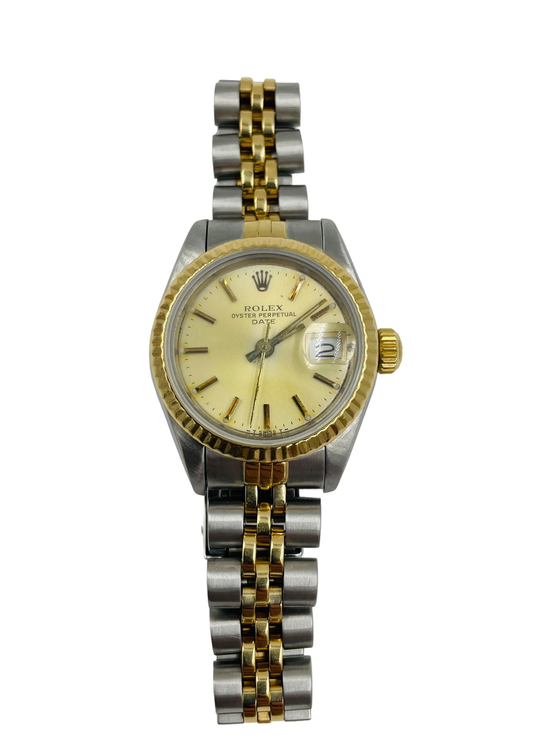 Ladies 2tone yellow gold and stainless steel Rolex date wristwatch, circa 1984.

DESCRIPTION:  Rolex Date 18k yellow gold and stainless steel 26 mm women's wristwatch,  circa 1984, reference            
# 69173.  It has light superficial scratches