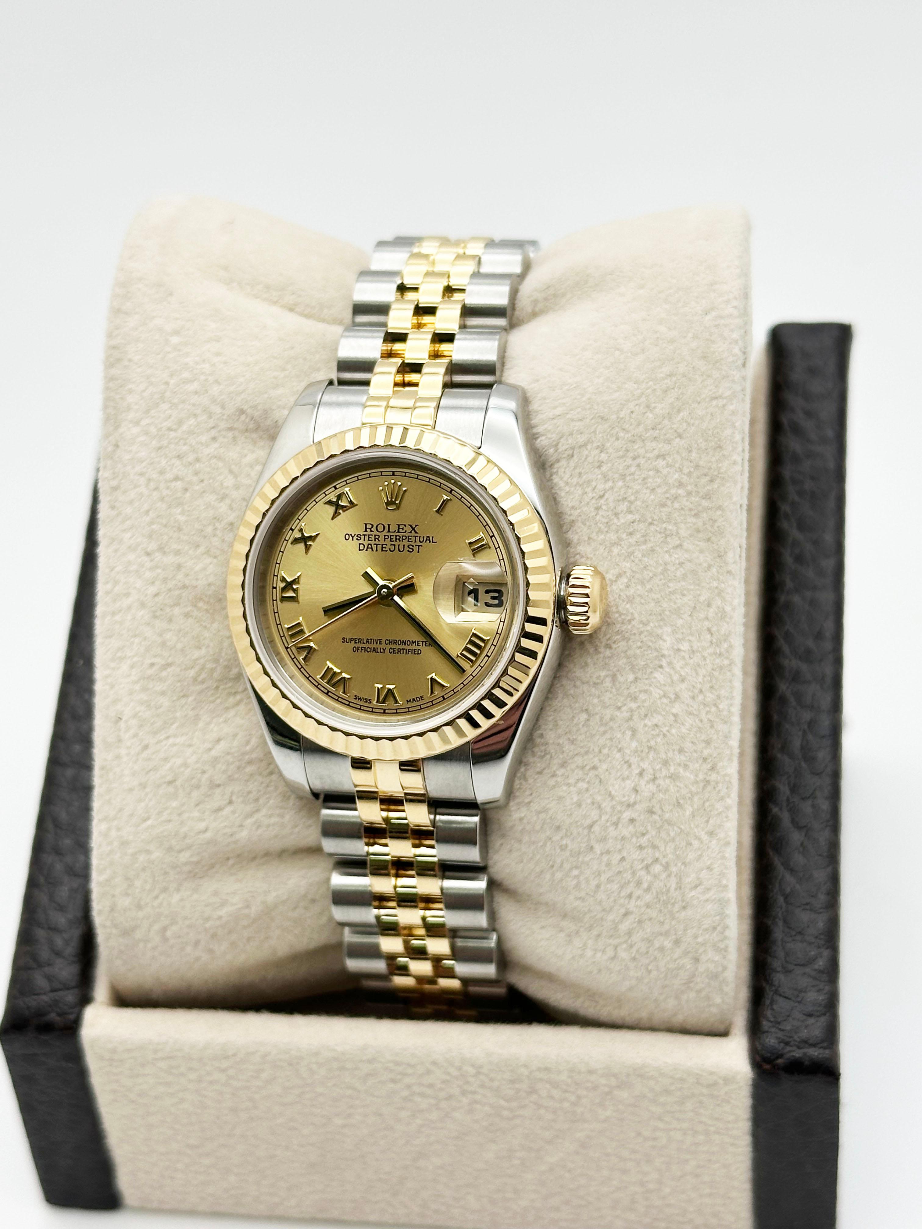 Style Number: 179173



Serial: D131***



Year: 2006

 

Model: Rolex Ladies Datejust 

 

Case Material: Stainless Steel 

 

Band: 18K Yellow Gold & Stainless Steel 

  

Bezel: 18K Yellow Gold Fluted Bezel 

  

Dial: Champagne Roman Dial 

