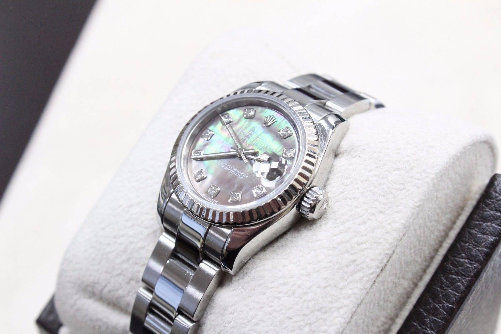 Style Number: 179174
Serial: D327***
Year: 2005
Model: Datejust
Case: Stainless Steel
Band: Stainless Steel
Bezel: 18K White Gold
Dial: Original Tahitian Mother of Pearl Diamond Dial
Face: Sapphire Crystal
Case Size: 26MM
Includes: 
-Rolex Box &