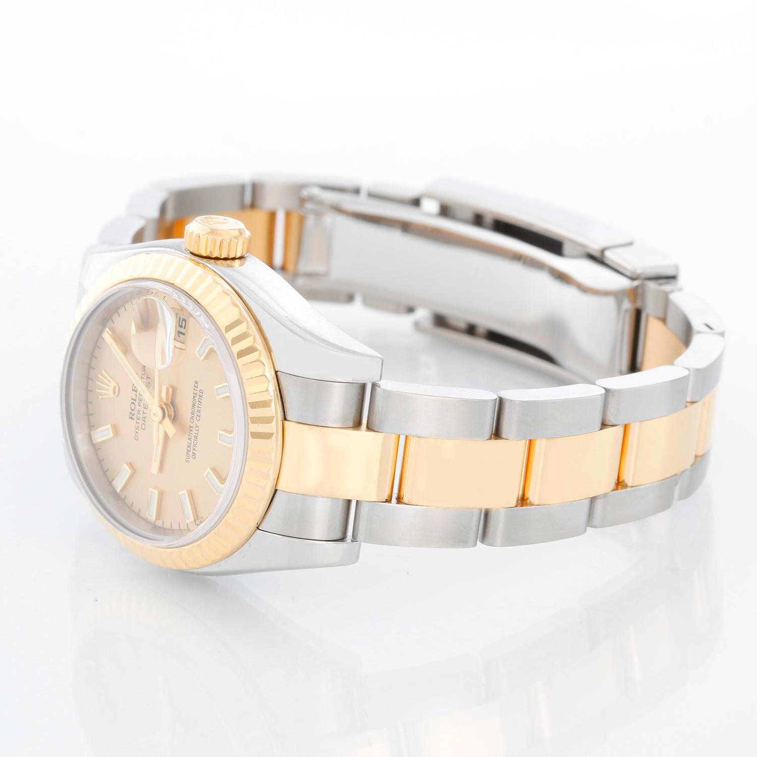 Rolex Ladies Datejust 2-Tone Watch 179173 - Automatic winding, Quickset, 31 jewels, sapphire crystal. Stainless steel case with 18k yellow gold fluted bezel ( 26 mm). Champagne dial with stick hour markers. Stainless steel and 18k yellow gold hidden