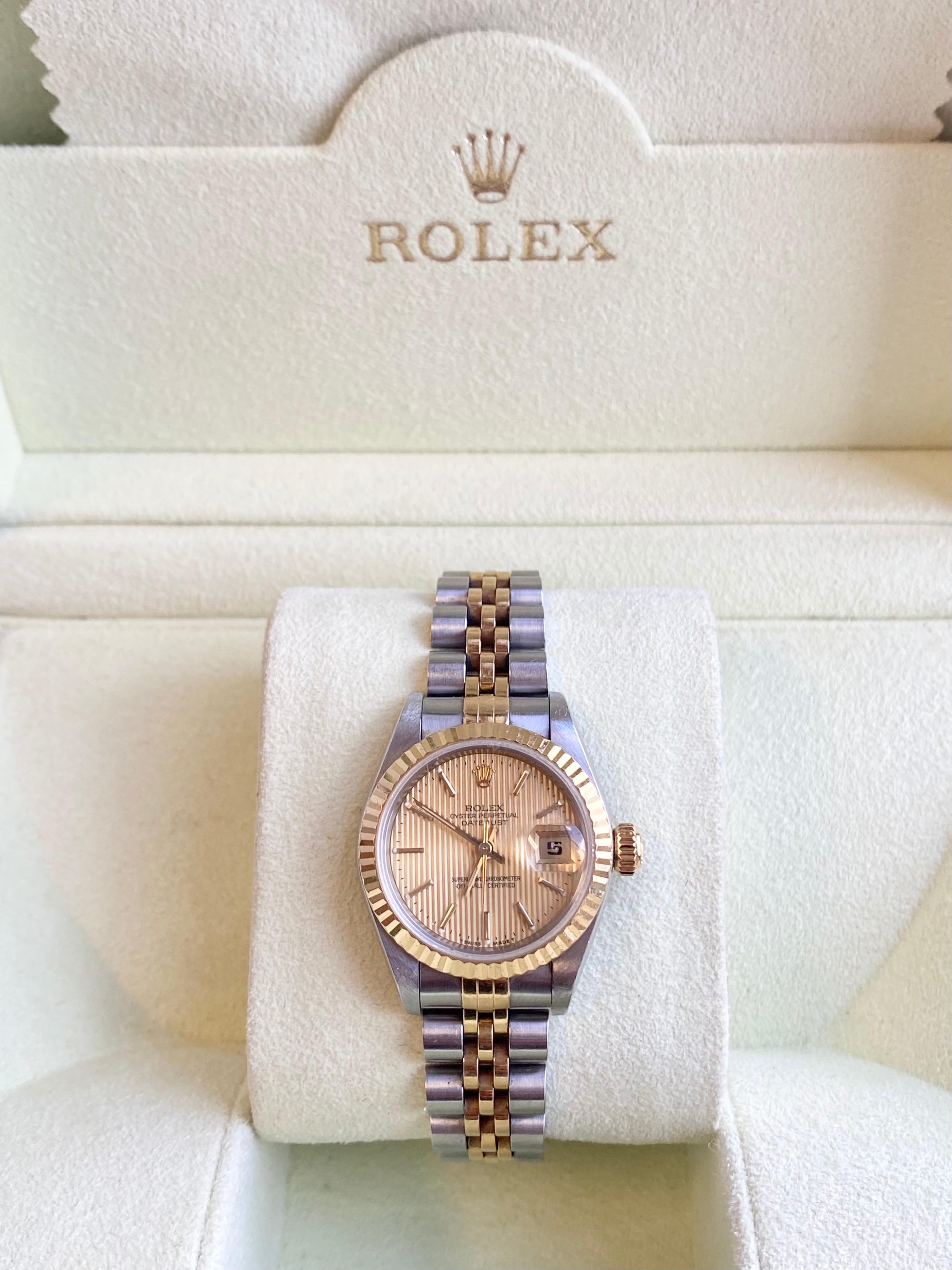 Rolex Ladies DateJust with gold fluted bezel and textured gold stick marker dial. Fitting for everyday wear or special occasions, this watch's quality is unrivaled. A classic among Rolex timepieces with an aesthetic that has passed the test of time