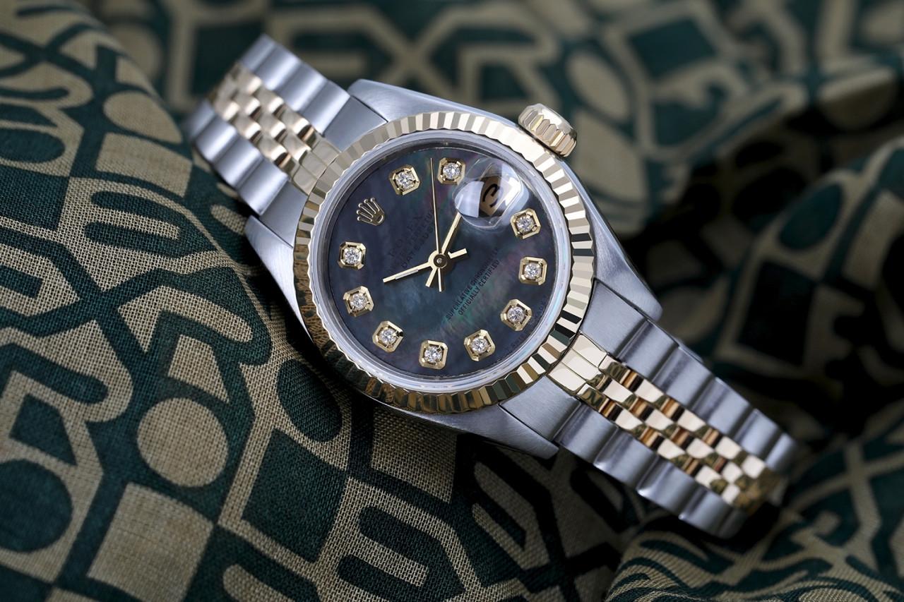 Ladies Vintage Rolex 26mm Datejust Two Tone Black MOP Mother Of Pearl Dial with Diamonds 69173.

This watch is in like new condition. It has been polished, serviced and has no visible scratches or blemishes. All our watches come with a standard 1