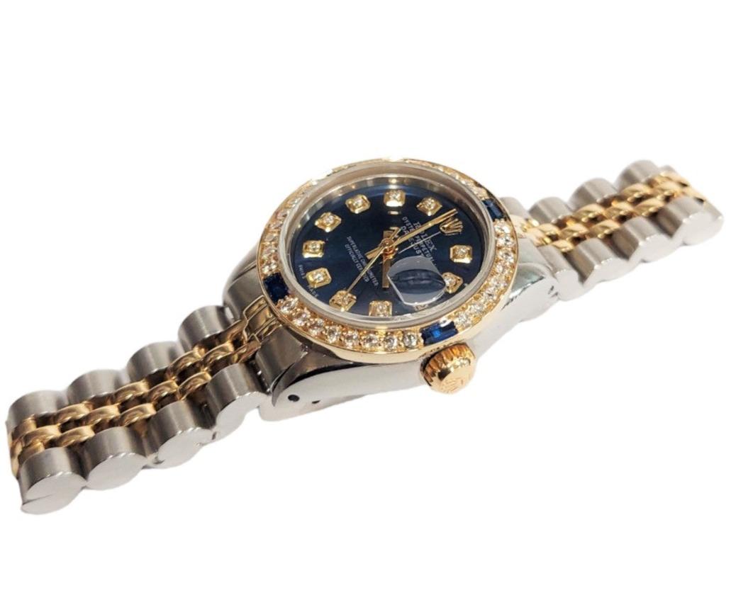 (Watch Description)
Brand - Rolex
Gender - Ladies
Model - 6917 Datejust
Metals - Steel / Yellow Gold
Case size - 26mm
Bezel - Yellow Gold Diamond/Sapphire
Crystal - sapphire
Movement - Automatic Cal.2035
Dial - Refinished Blue Diamond
Wrist band -