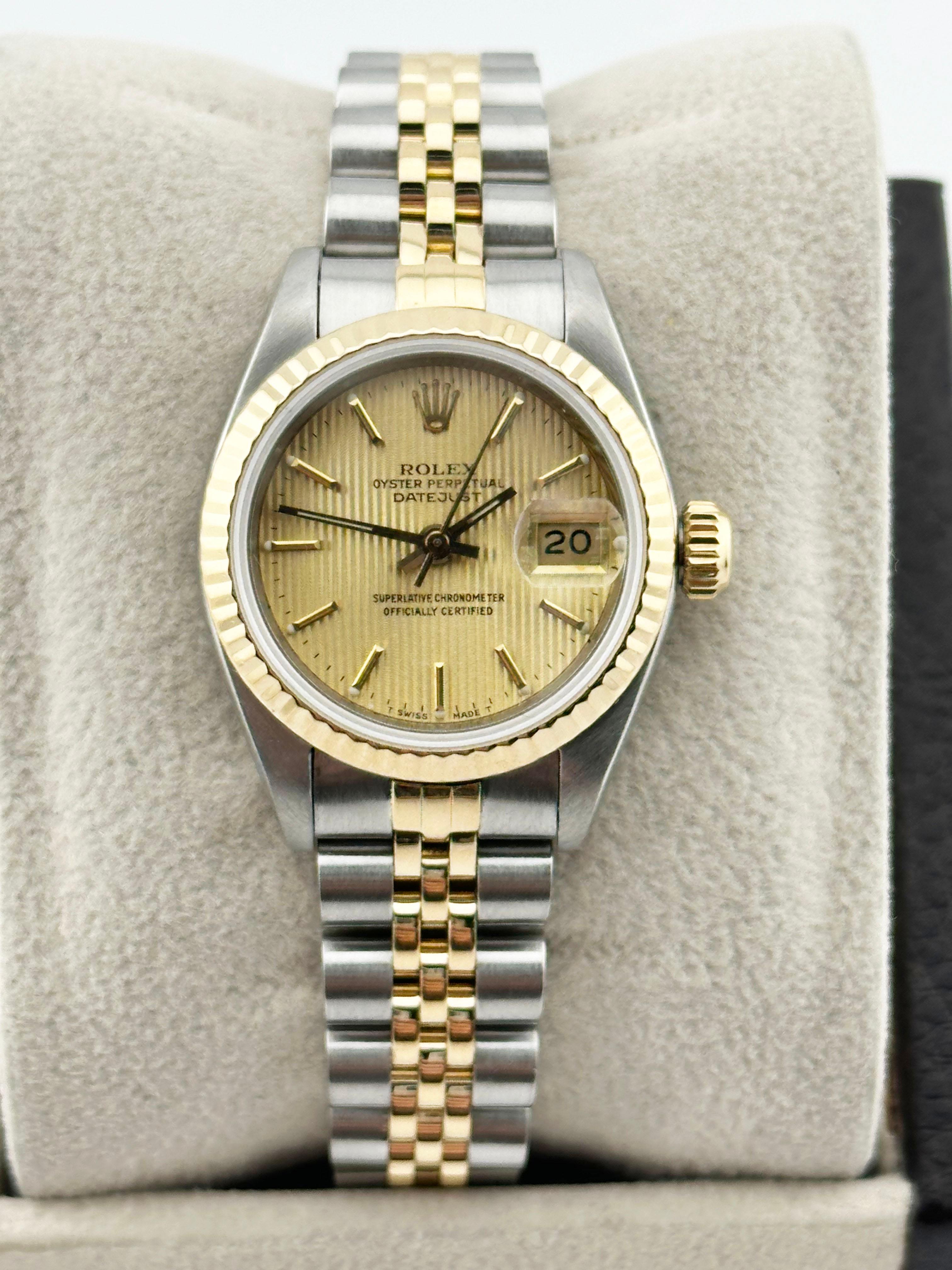 Style Number: 69173

Serial: L893***

Year: 1989

Model: Rolex Ladies Datejust 

Case Material: Stainless Steel 

Band: 18K Yellow Gold & Stainless Steel Jubilee Band 

Bezel: 18K Yellow Gold Fluted Bezel 

Dial: Champagne Tapestry Dial 

Face: