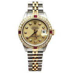 Rolex Montre Datejust 69173 pour femmes avec cadran en diamants, rubis et lunette en acier et or 18 carats