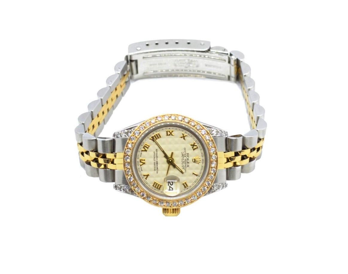 Brand - Rolex
Gender - Ladies
Condition - Pre owned
Model - 69173 datejust 
Metals - solid gold & stainless steel 
Case size - 26mm
Bezel - yellow gold diamond
Crystal - sapphire
Movement - automatic caliber 2135  - quick set
Dial - refinished