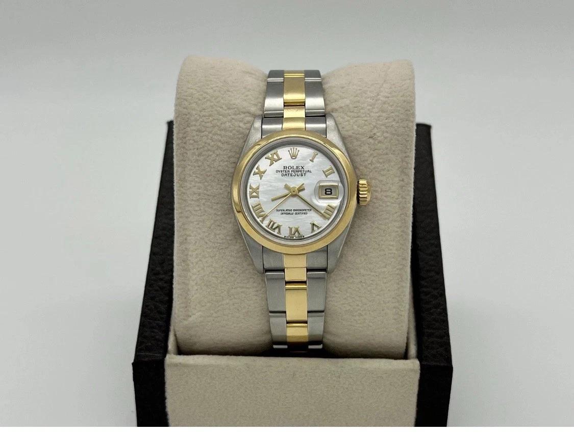 Style Number: 79163

Serial: Y904***

Year: 2002

Model: Rolex Ladies Datejust 

Case Material: Stainless Steel 

Band: 18K Yellow Gold & Stainless Steel 

Bezel: 18K Yellow Gold 

Dial: Factory Original White Mother Of Pearl Roman Numeral