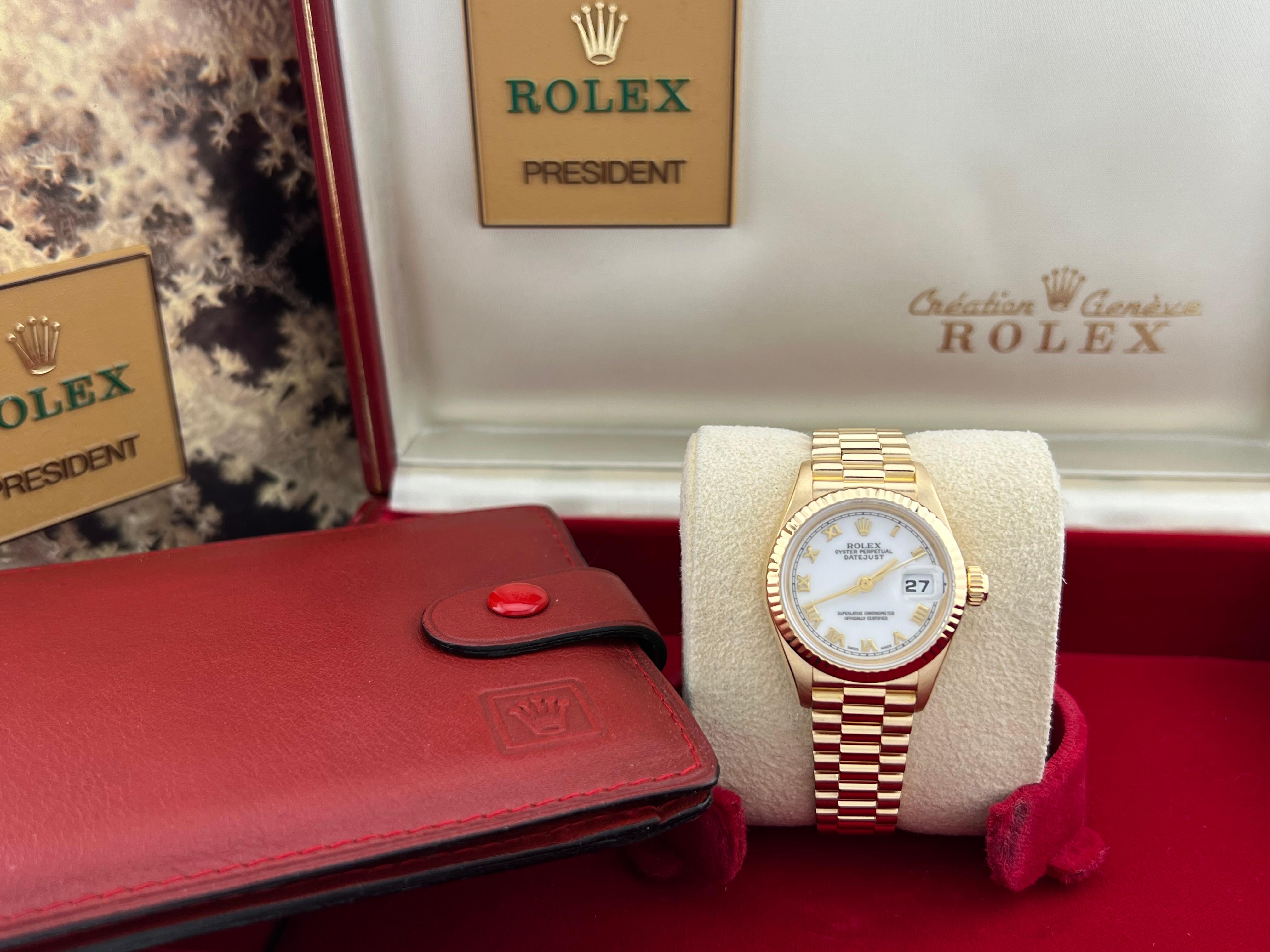 Style Number: 69178



Serial: T303***



Year: 1996

 

Model: Rolex Ladies Datejust President 

 

Case Material: 18K Yellow Gold 

 

Band:  18K Yellow Gold 

  

Bezel:  18K Yellow Gold 

  

Dial: White Dial with Roman Numeral Hour Markers 

