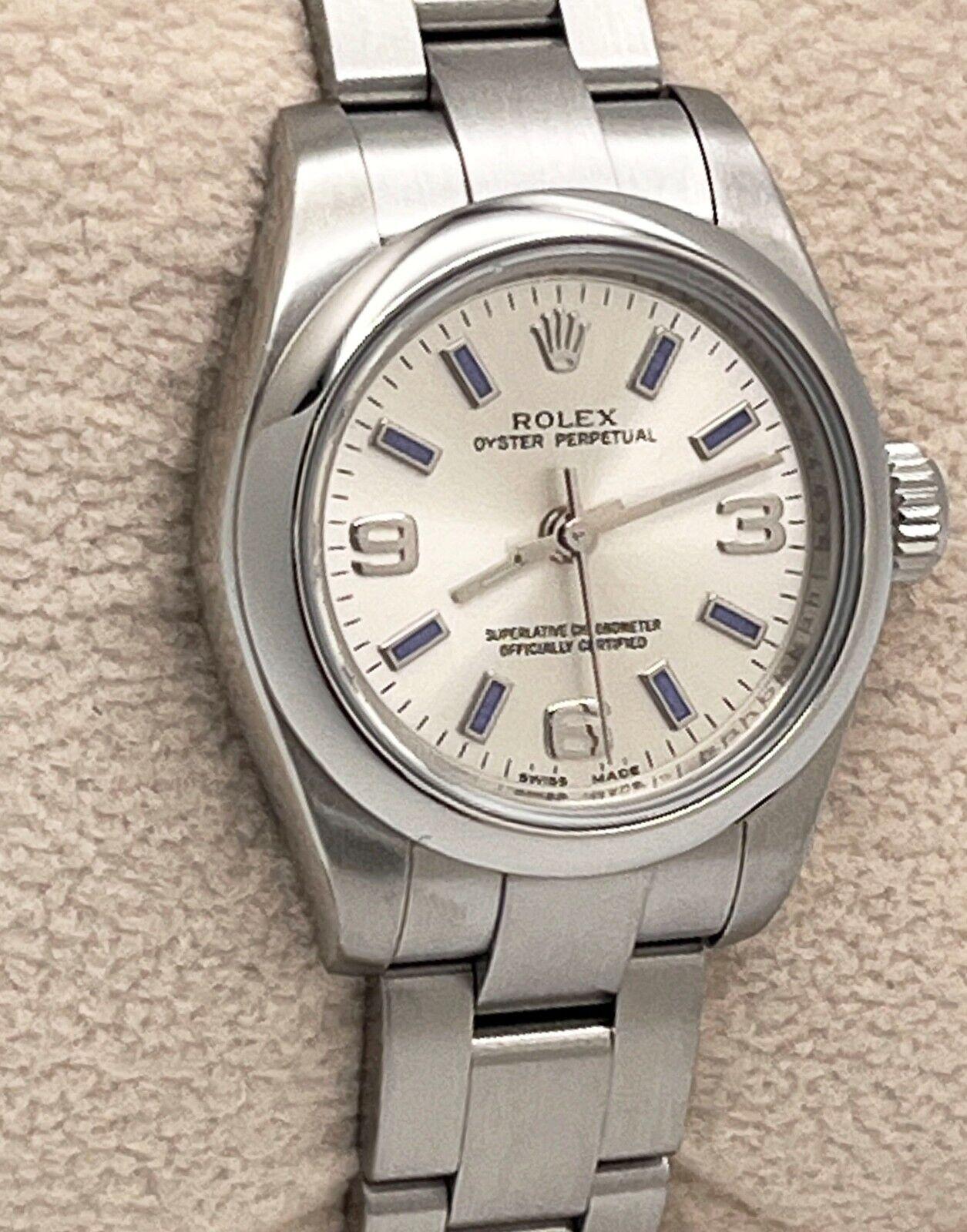 Style Number: 176200
Serial: G820***
Year: 2010
Model: Ladies Oyster Perpetual
Case Material: Stainless Steel
Band: Stainless Steel
Bezel: Stainless Steel
Dial: Silver with Blue Markers
Face: Sapphire Crystal
Case Size: 26mm


Includes: 
-Elegant