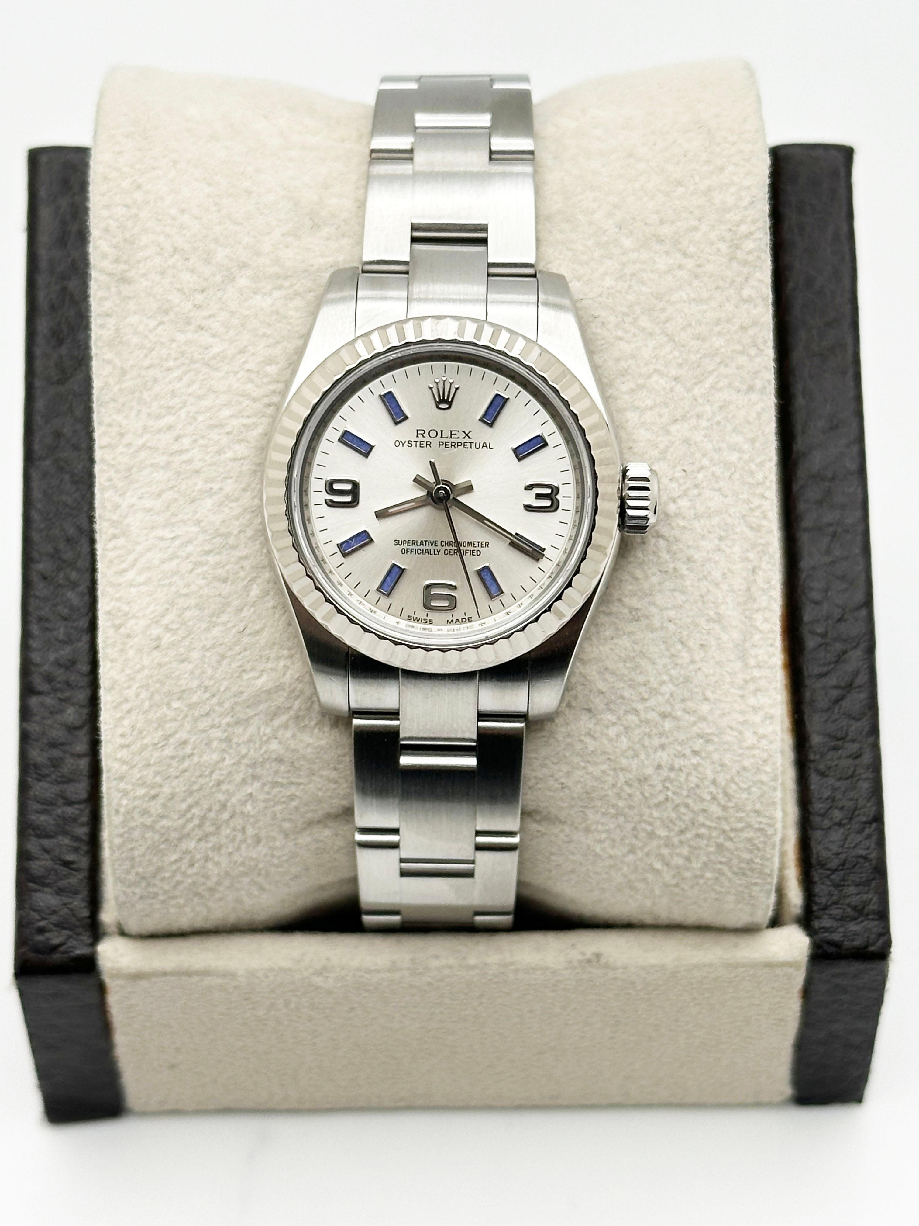 Style Number: 176234

Serial: M119***

Year: 2007
 
Model: Rolex Oyster Perpetual 
 
Case Material: Stainless Steel
 
Band: Stainless Steel
  
Bezel: 18K White Gold Fluted Bezel 
  
Dial: Silver Dial with Blue Markers and Arabic Numeral 3, 6 & 9
