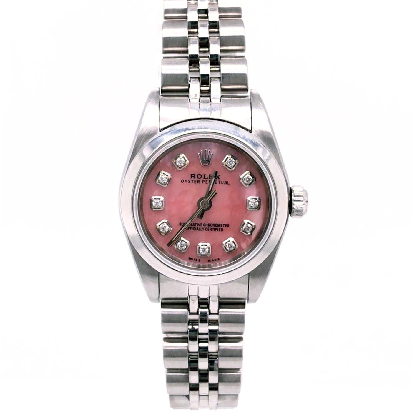 Ladies Rolex Oyster Perpetual in stainless steel, Ref# 76080. On a stainless steel Oyster bracelet with a deployment clasp. Smooth bezel with sapphire crystal. The case diameter is 24mm. Self-winding movement. Pink dial with applied, framed with