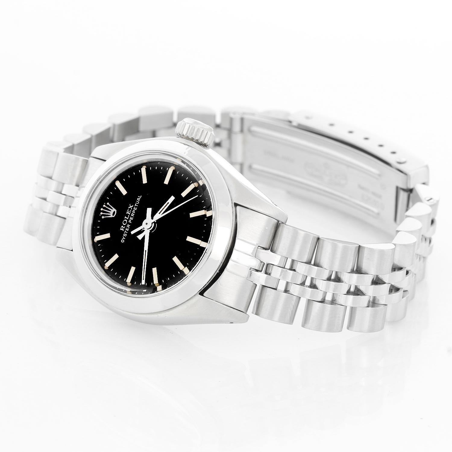 Rolex Ladies Oyster Perpetual No-Date Stainless Steel Watch 6718 - Automatic winding. Stainless steel case with smooth bezel (26 mm ). Black dial with stick markers. Stainless steel Jubilee bracelet. Pre-owned with custom box.