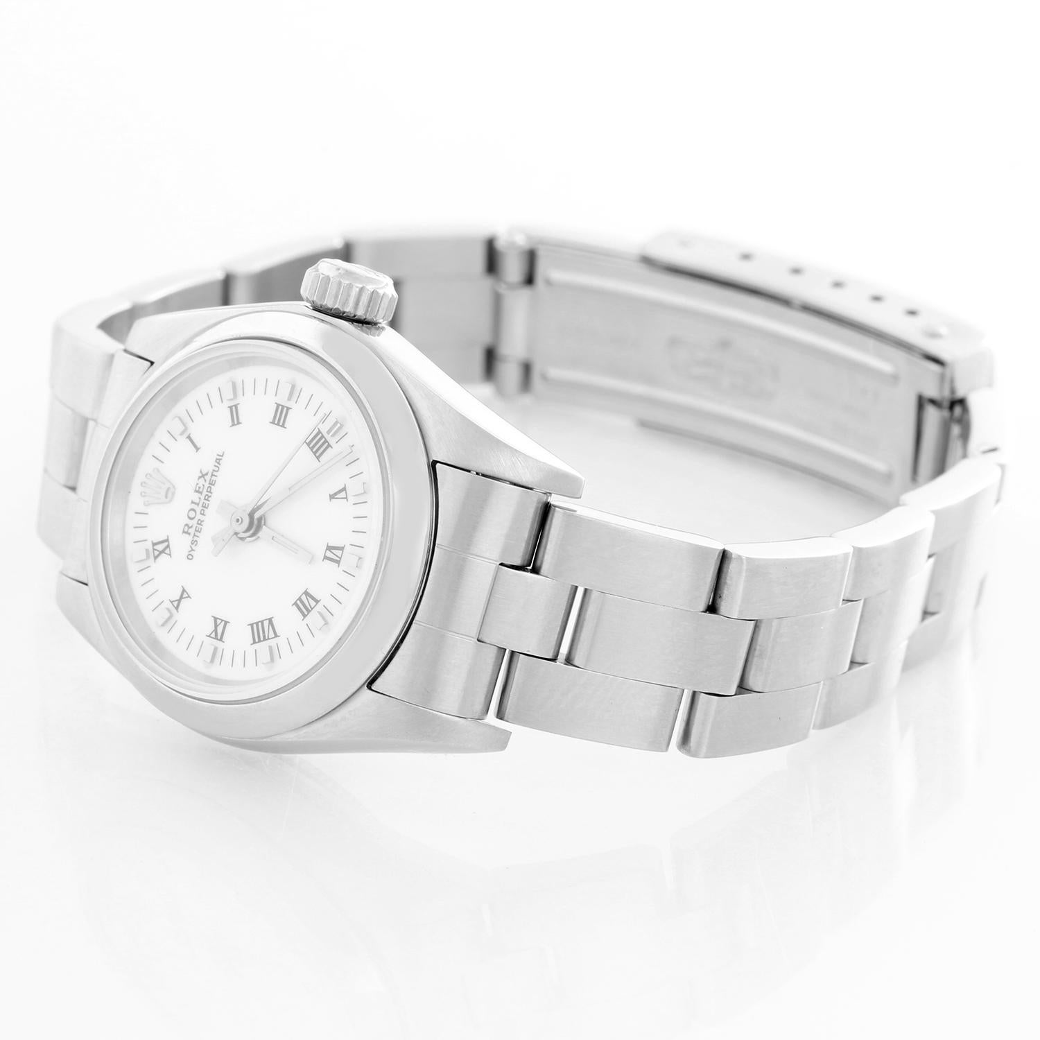 Rolex Ladies Oyster Perpetual No-Date Stainless Steel Watch 67180 - Automatic winding. Stainless steel case with smooth bezel (26 mm) . White dial. Stainless steel Oyster bracelet. Pre-owned with custom box.