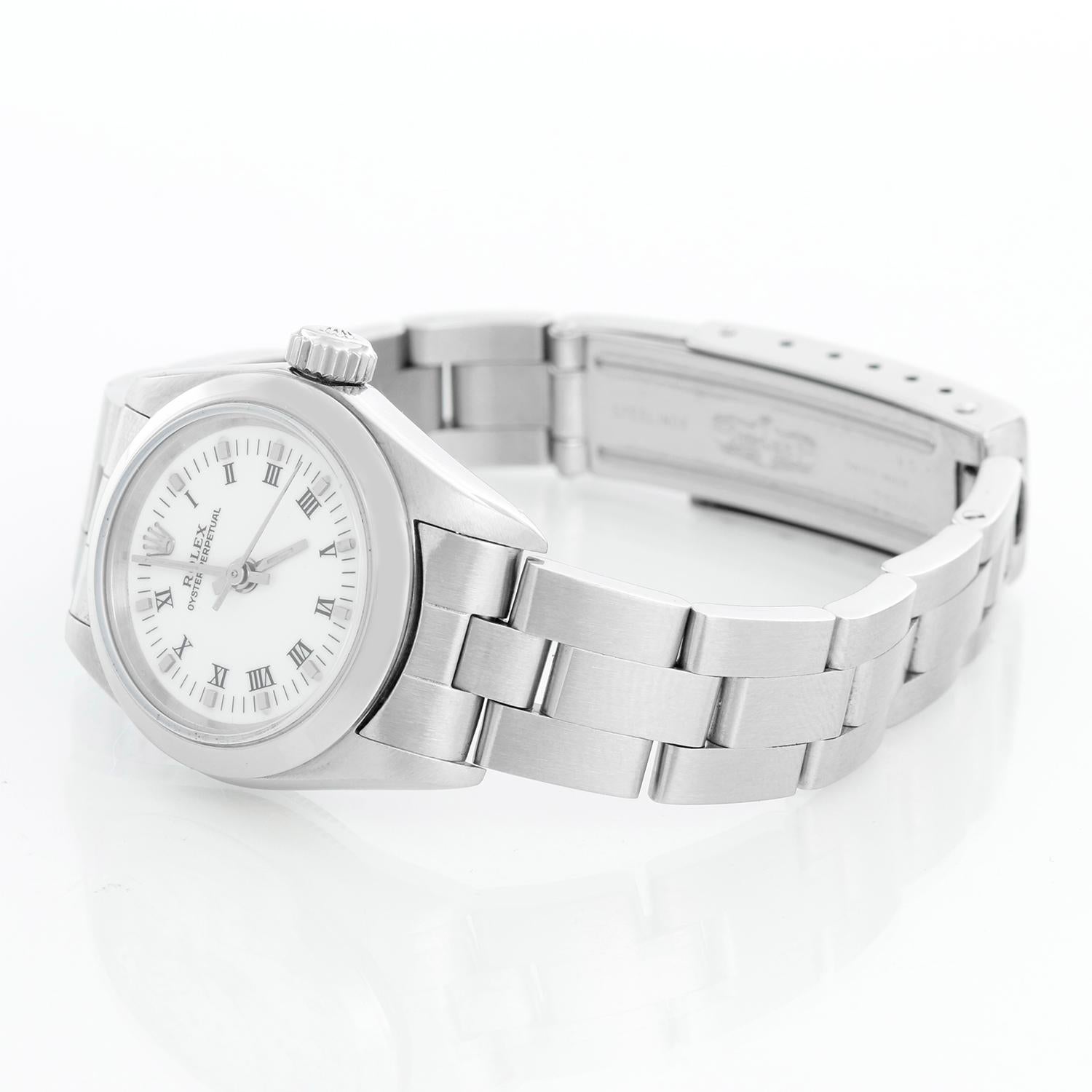 Rolex Ladies Oyster Perpetual No-Date Stainless Steel Watch 67180 - Automatic winding. Stainless steel case with smooth bezel (26 mm). White dial . Stainless steel Oyster bracelet. Pre-owned with custom box.