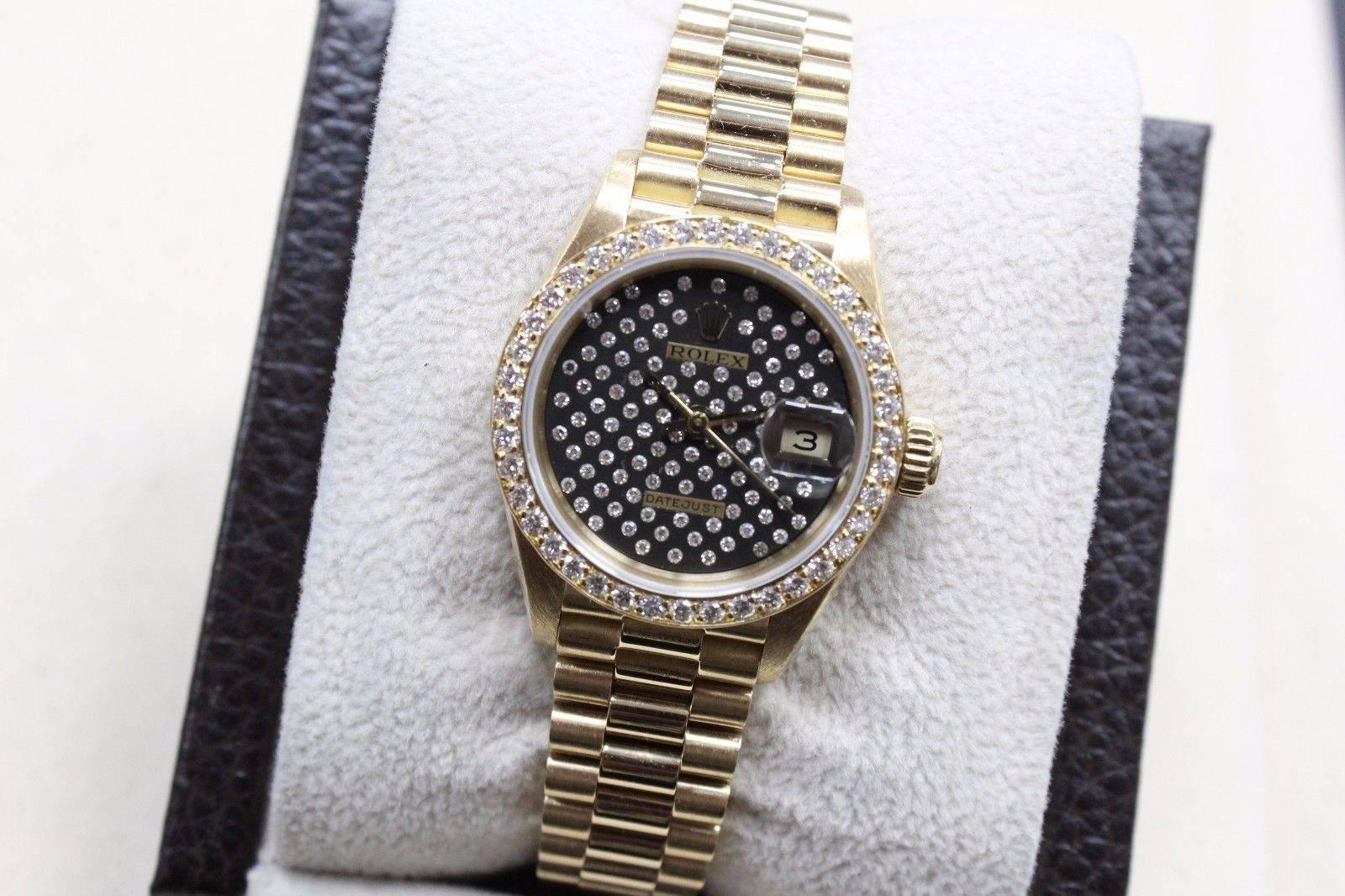 Style Number: 69138
Serial: 9058***
Model: Ladies President 
Case: 18K Yellow Gold
Band: 18K Yellow Gold
Bezel: Factory Diamond Bezel 
Dial: Factory Diamond Dial 
Face: Sapphire Crystal
Case Size: 26mm
Includes: 
-Elegant Watch Box
-Certified