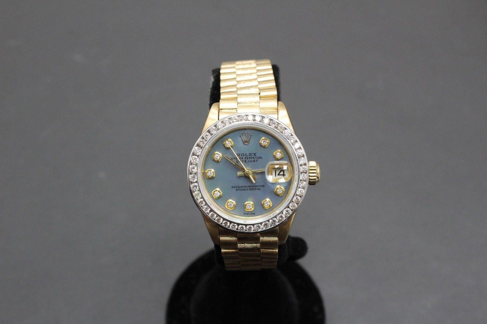 Style Number: 6917

Serial: 6286***

Model: President Datejust 

Case Material: 18K Yellow Gold

Band: 18K Yellow Gold

Bezel: Custom Diamond Bezel 

Dial: Custom Blue MOP Diamond Dial 

Face: Sapphire Crystal 

Case Size: 26mm 

Includes: 

-Rolex