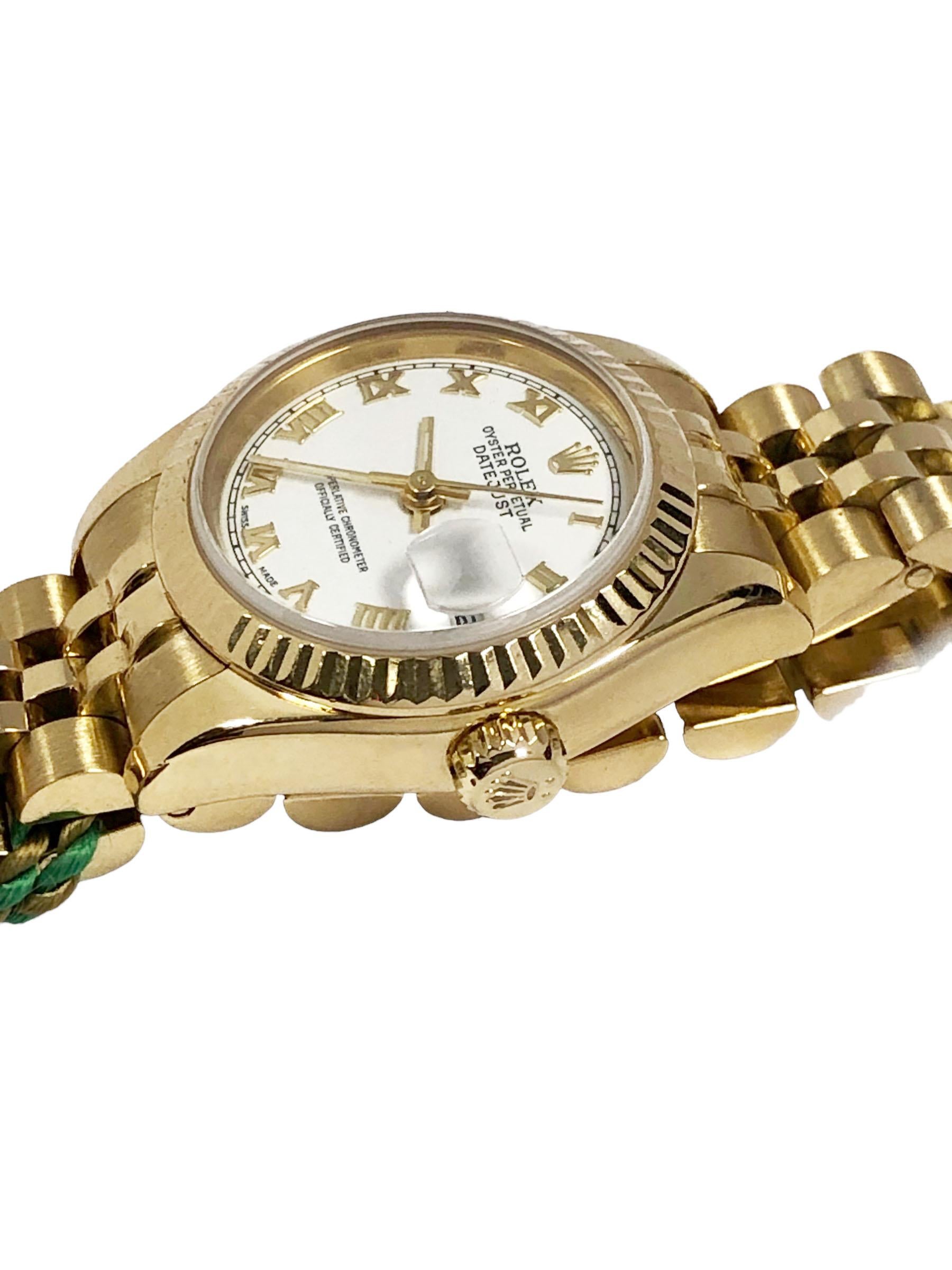 Circa 2004 Rolex Ladies President model Wrist Watch, Reference 179178. Having one owner and was seldom worn, 26 M.M 18K yellow Gold 3 Piece Water resistant case with Fluted Bezel, Automatic, Self winding movement, White Dial with Raised Gold Roman