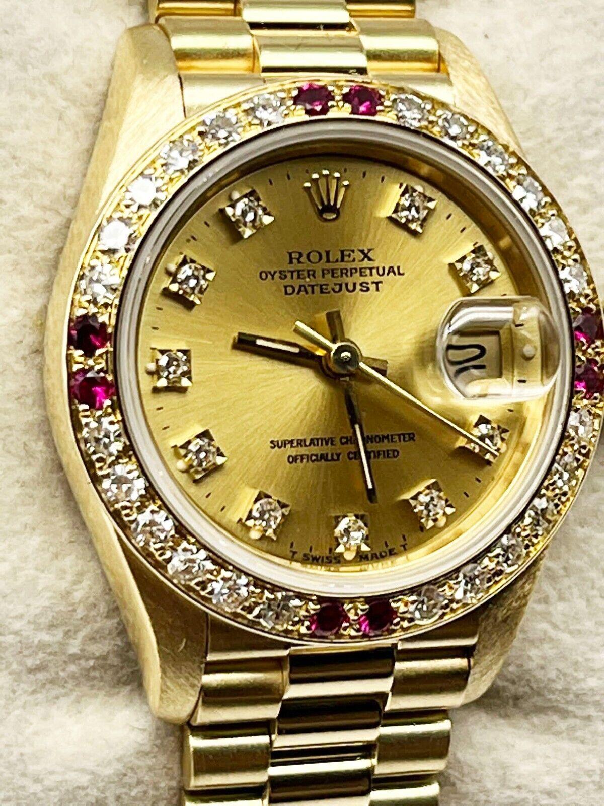 Style Number: 69178

Serial: E841***

Year: 1990

Model: Datejust

Case Material: 18K Yellow Gold

Band: 18K Yellow Gold 

Bezel: Custom Diamond and Ruby bezel

Dial: Custom Diamond dial

Face: Sapphire Crystal

Case Size: 26mm

Includes: 

-Elegant