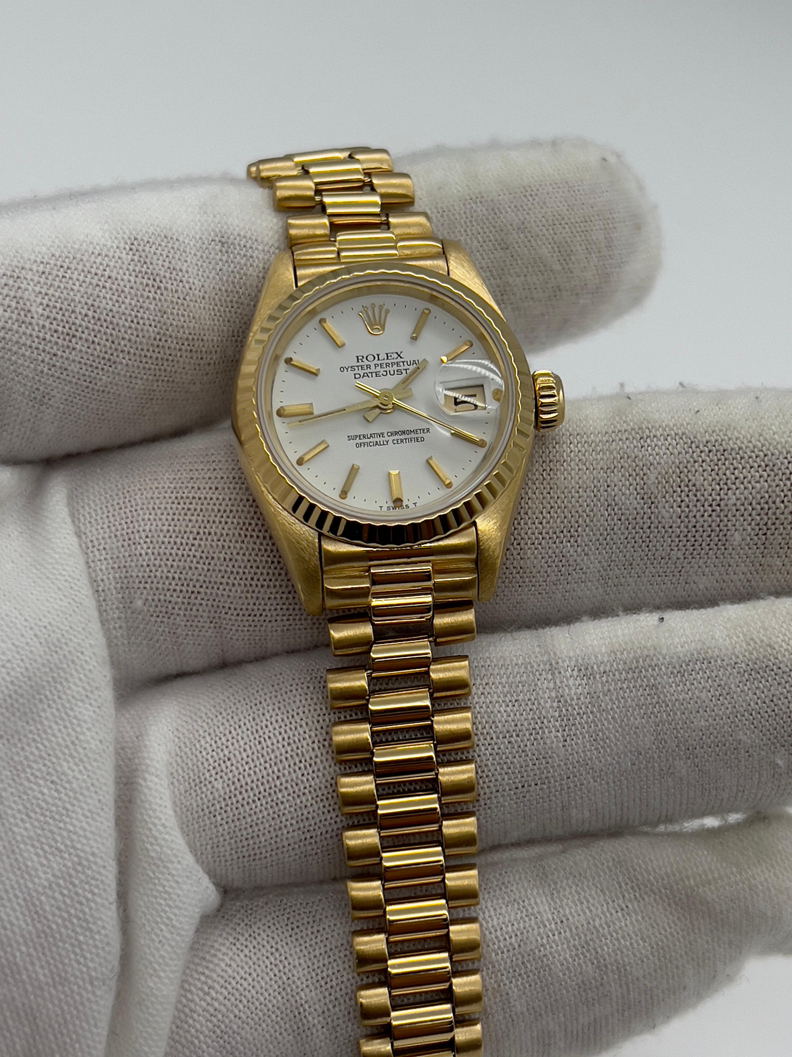 Style Number: 69178
Serial: 8675***
Year: 1985
Model: Ladies President Datejust 
Case Material: 18K Yellow Gold
Band: 18K Yellow Gold 
Bezel: 18K Yellow Gold 
Dial: White 
Face: Sapphire Crystal 
Case Size: 26mm 
Includes: 
-Elegant Watch