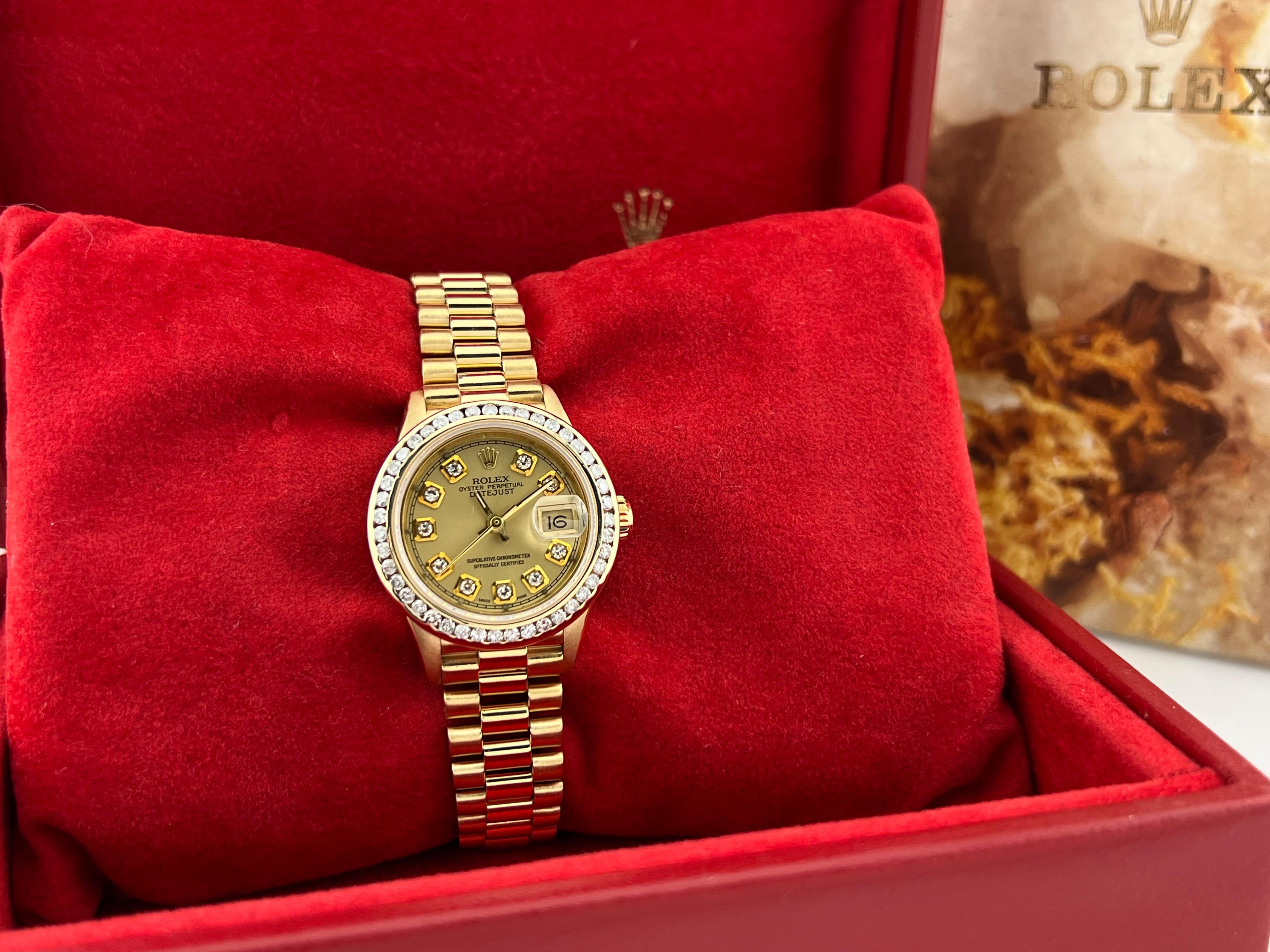 Style Number: 69178

Serial: E193***

Year: 1990

Model: Rolex Ladies President 

Case Material: 18K Yellow Gold 

Band: 18K Yellow Gold 

Bezel: Custom Diamond Bezel 

Dial: Custom Diamond Dial 

Face: Sapphire Crystal 

Case Size: 26mm