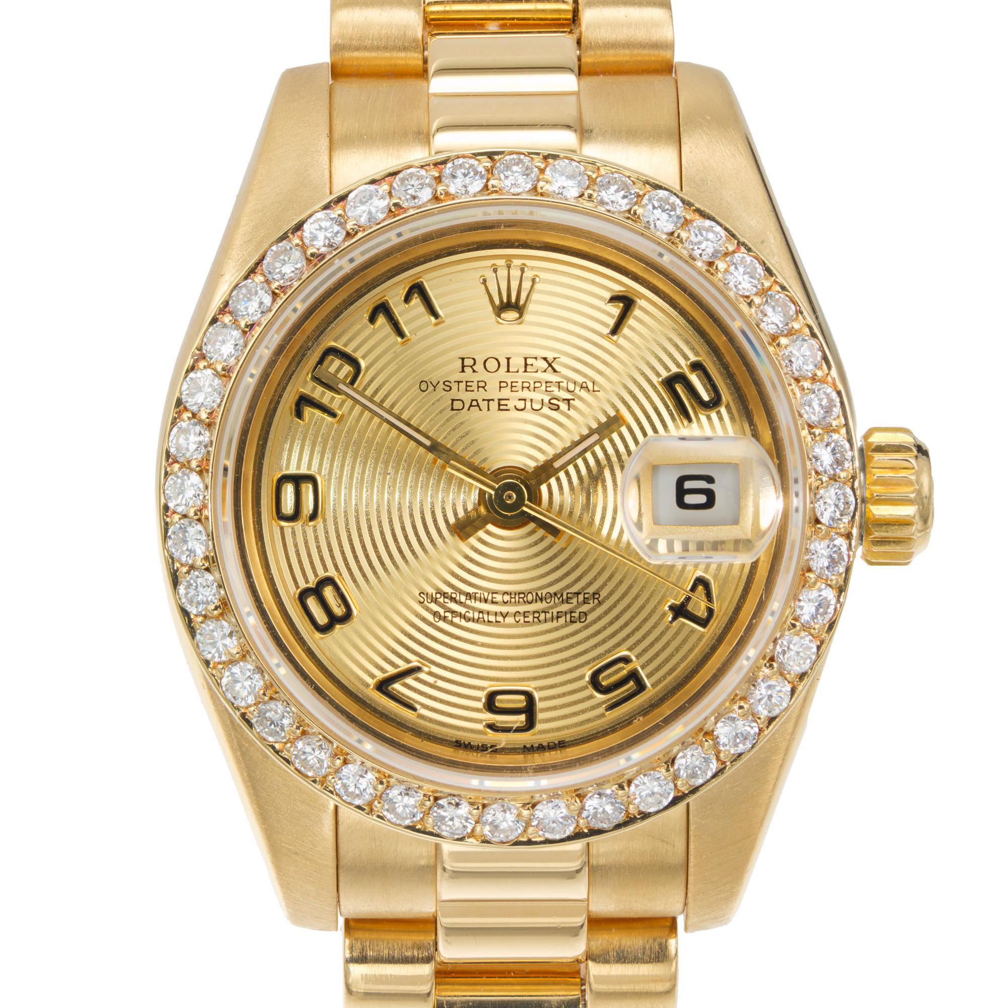 Lady's Rolex President Date Just turntable wristwatch model 179138. Factory Turntable dial with a diamond bezel in 18k yellow gold. 6.5 inches. The band oyster band has no visible stretch or wear. Circa 2001. Rolex box included. No papers. 

Length: