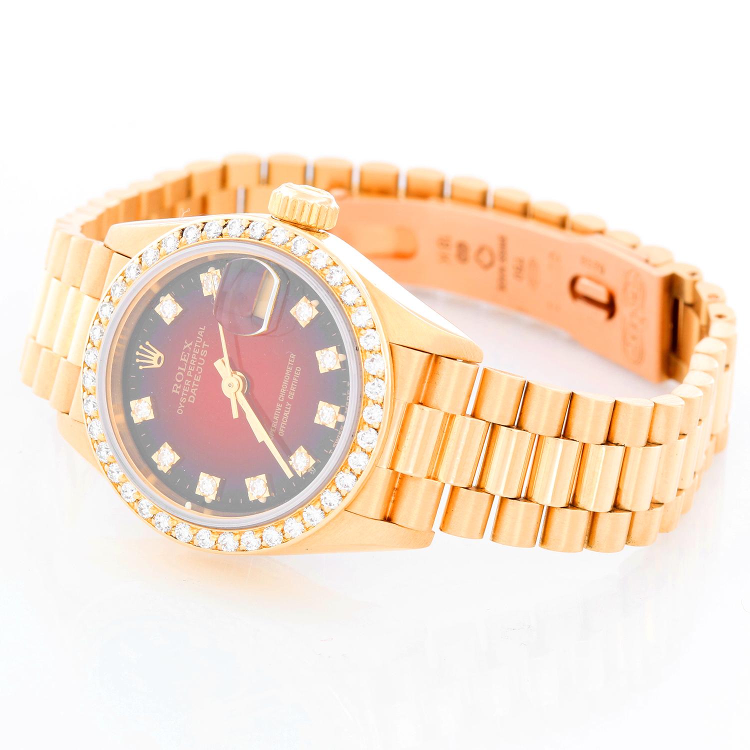 Rolex Ladies President, Model 69138 - Ladies automatic winding wristwatch. 18k yellow gold case with factory diamond bezel (26mm diameter). Sapphire crystal. Rolex factory Red Vignette dial with diamond hour markers. 18k yellow gold hidden-clasp