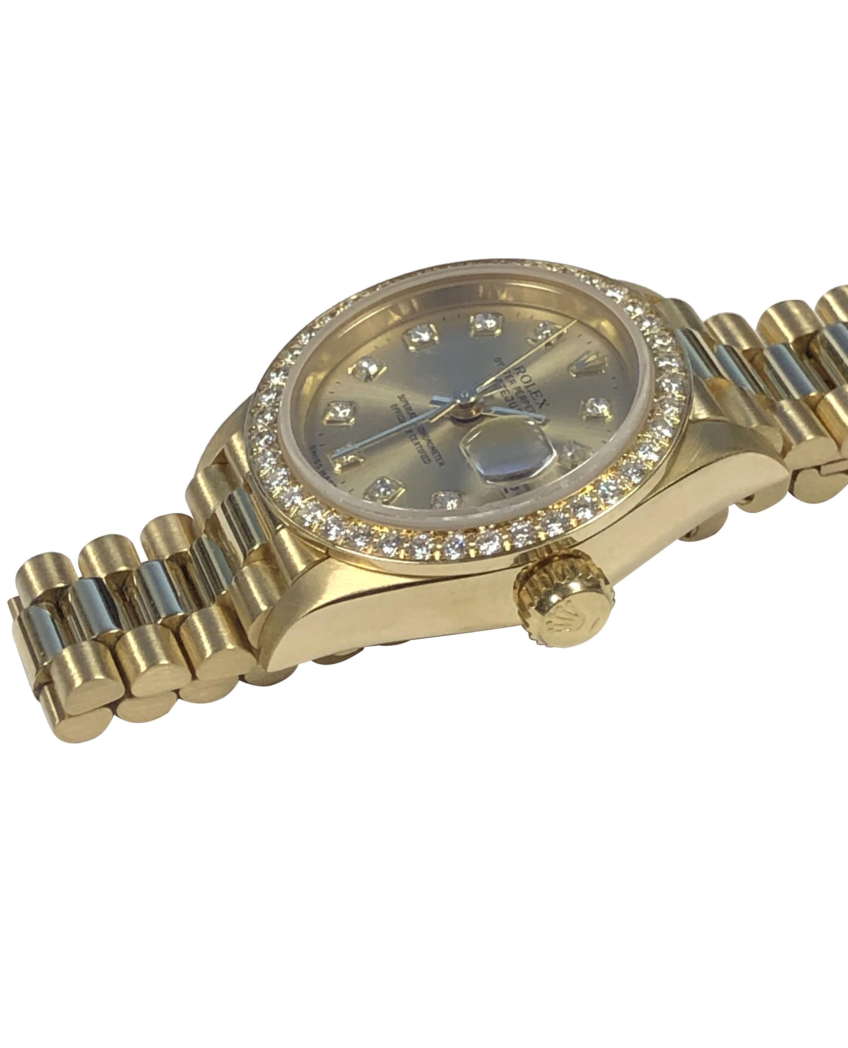 Circa 1995 Rolex Presidential model Ladies Reference 69138 Wrist Watch, 26 M.M. 18k Yellow Gold 3 piece water resistant Oyster case. Factory original Full cut Diamond bezel totaling approximately 1 Carat,  29 Jewel Caliber 2135 Automatic, self