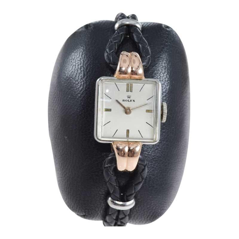FACTORY / HOUSE: Rolex Watch Company
STYLE / REFERENCE: Art Deco / Ref. 3911
METAL / MATERIAL: Stainless Steel and Rose Gold
DIMENSIONS: 25 mm X 15 mm
CIRCA: 1944 / 1945
MOVEMENT / CALIBER: Manual Winding / 17 Jewels / with Super Balance 
DIAL /