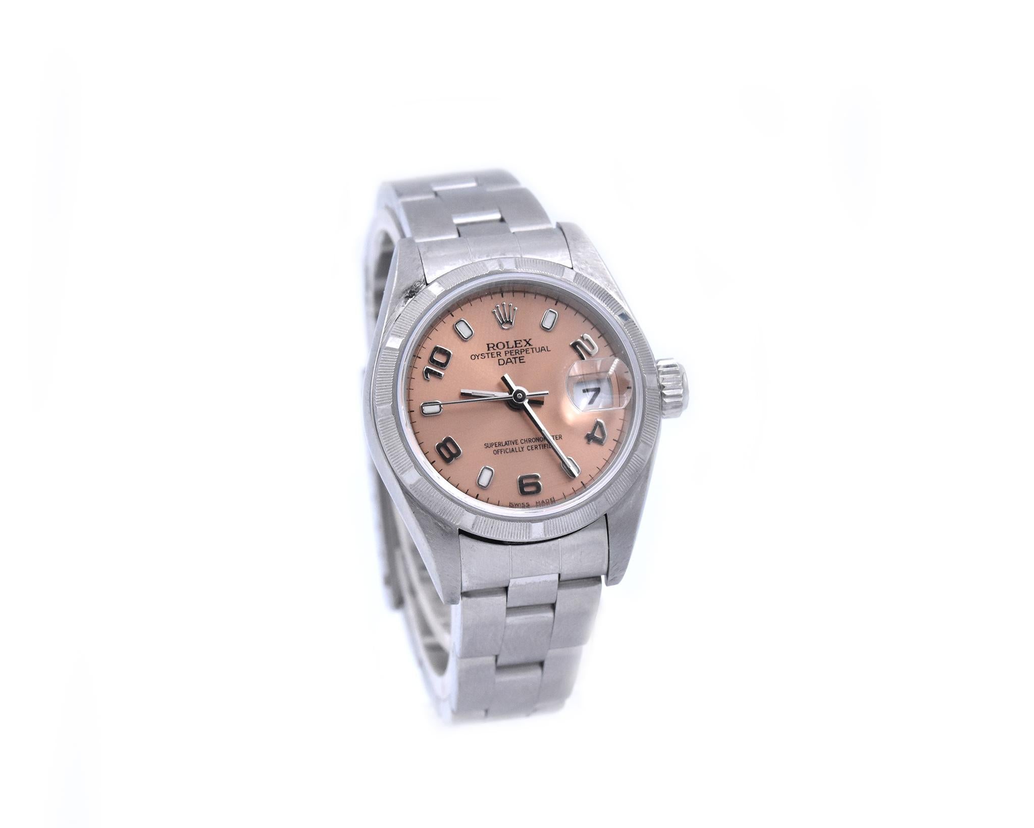 Movement: automatic
Function: hours, minutes, seconds, date at 3 o’clock 
Case: 26mm steel case, engine turned bezel, sapphire crystal
Band: Rolex stainless steel oyster bracelet
Dial: peach dial, luminescent alternating hour markers and