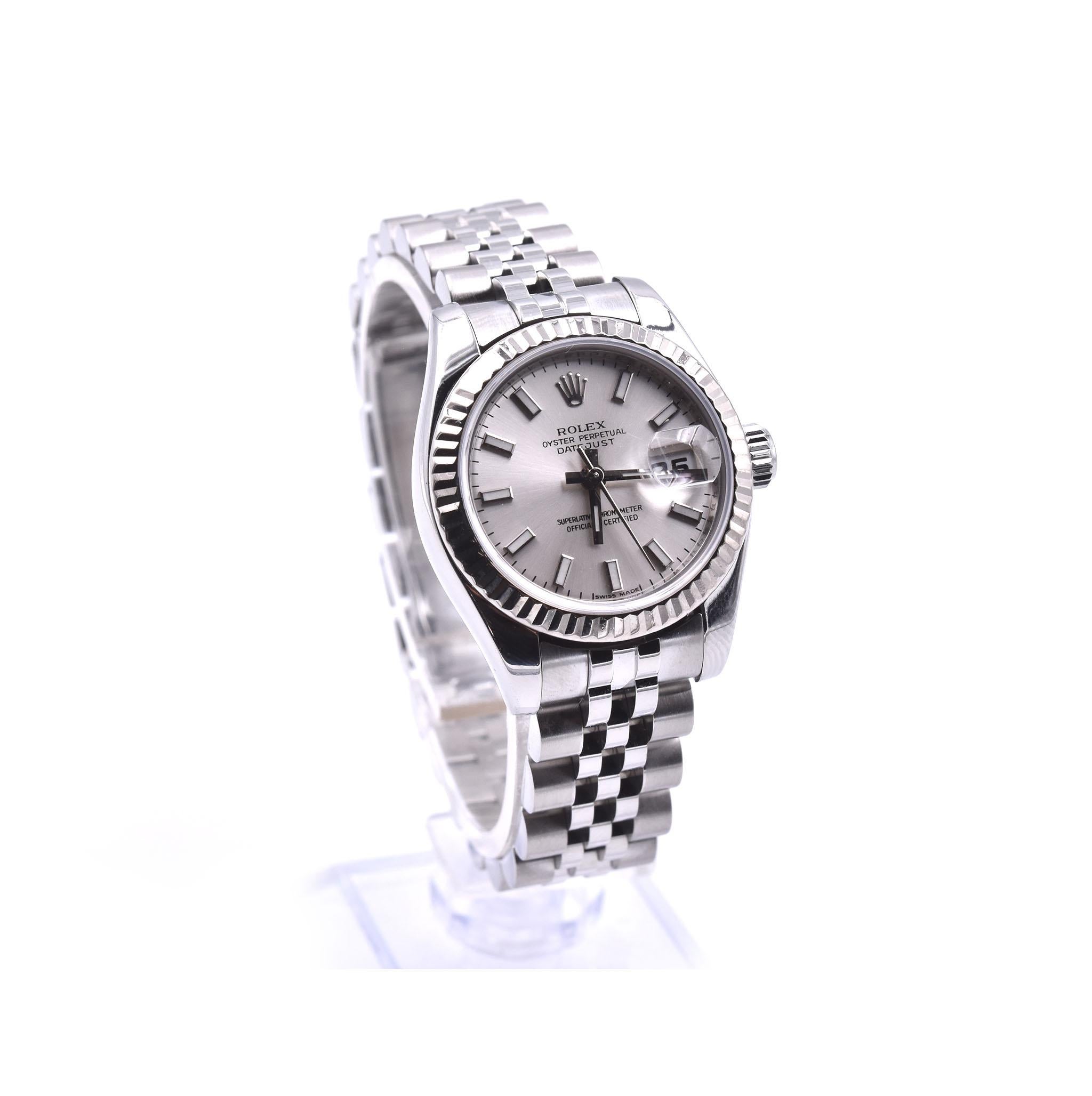 Movement: automatic 
Function: hours, minutes, seconds, date
Case: round 26mm stainless steel case with 18k white gold fluted bezel, sapphire protective crystal, screw-down crown, water resistant to 100 meters
Band: stainless steel jubilee bracelet