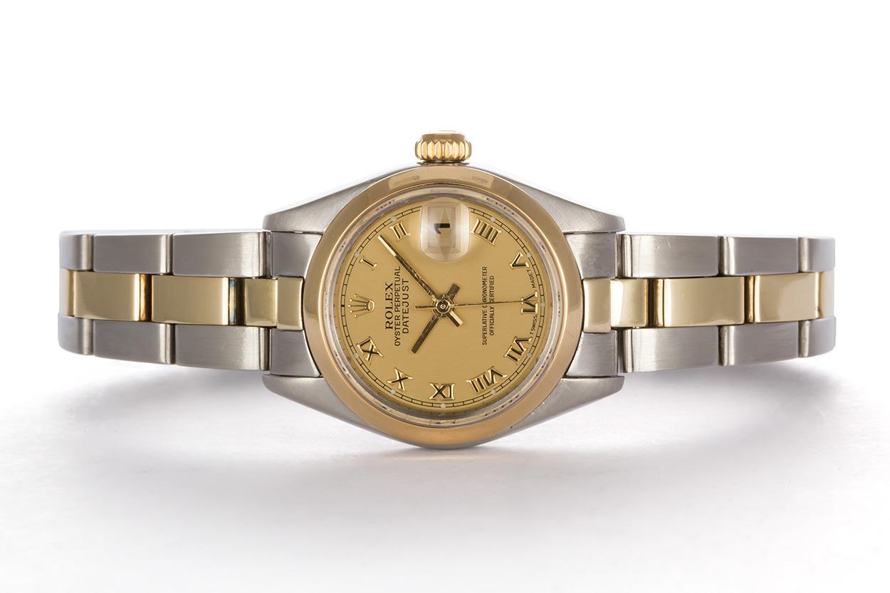 We are pleased to offer this like new 1999 Rolex Ladies Two Tone Datejust 79173. This watch features a Rolex factory champagne roman dial, smooth 18k yellow gold bezel and oyster bracelet. This is a classic ladies watch, timeless in its design. The