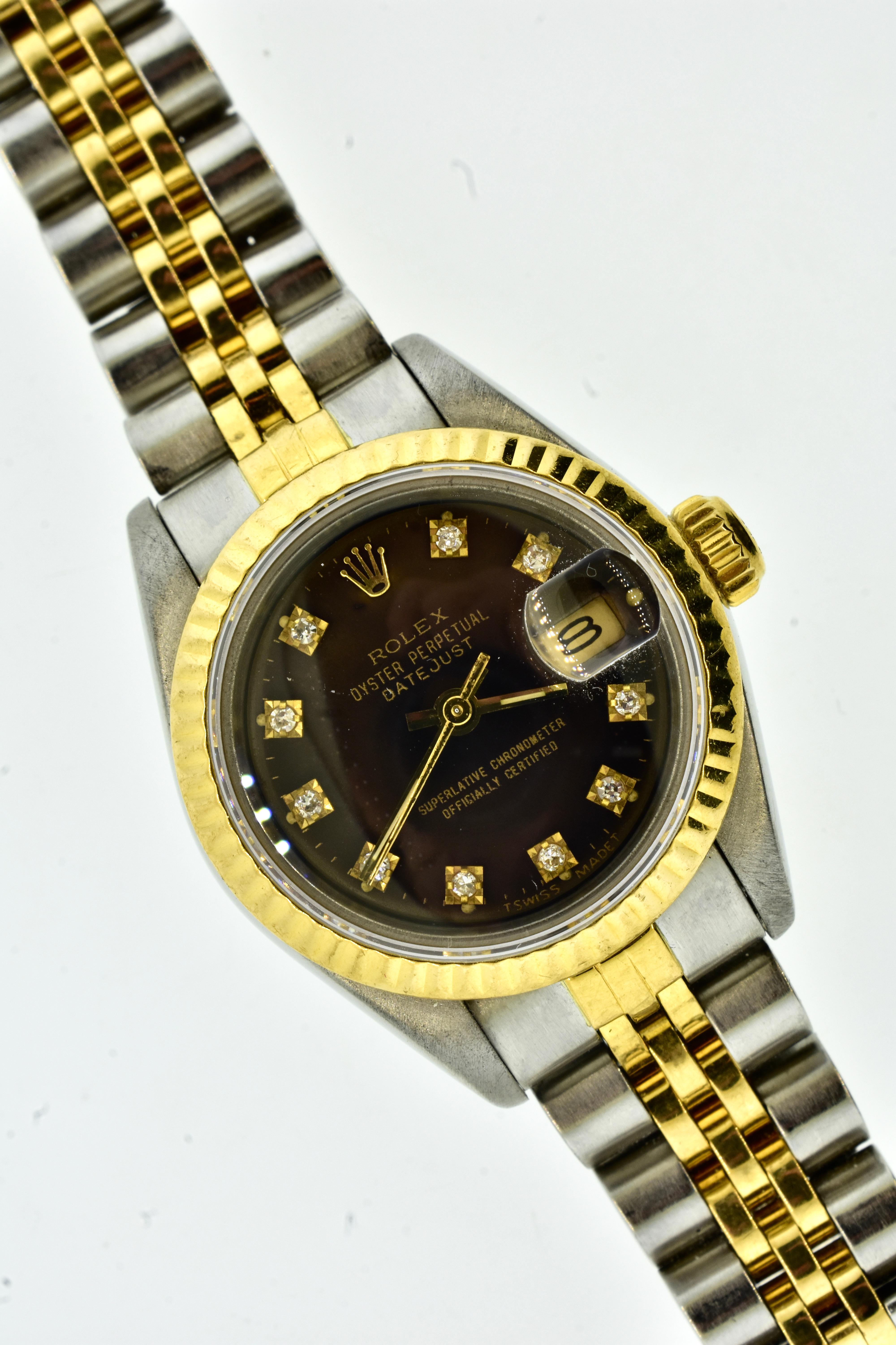 Rolex, Model No. 69173.  Stainless Steel and 18K Yellow Gold diamond hour markers with each surround in 18K yellow gold.  Movement is automatic, No. 2235.  Waterproof down to 100 meters - about 300 feet. Chocolate dial with fluted 18K yellow gold