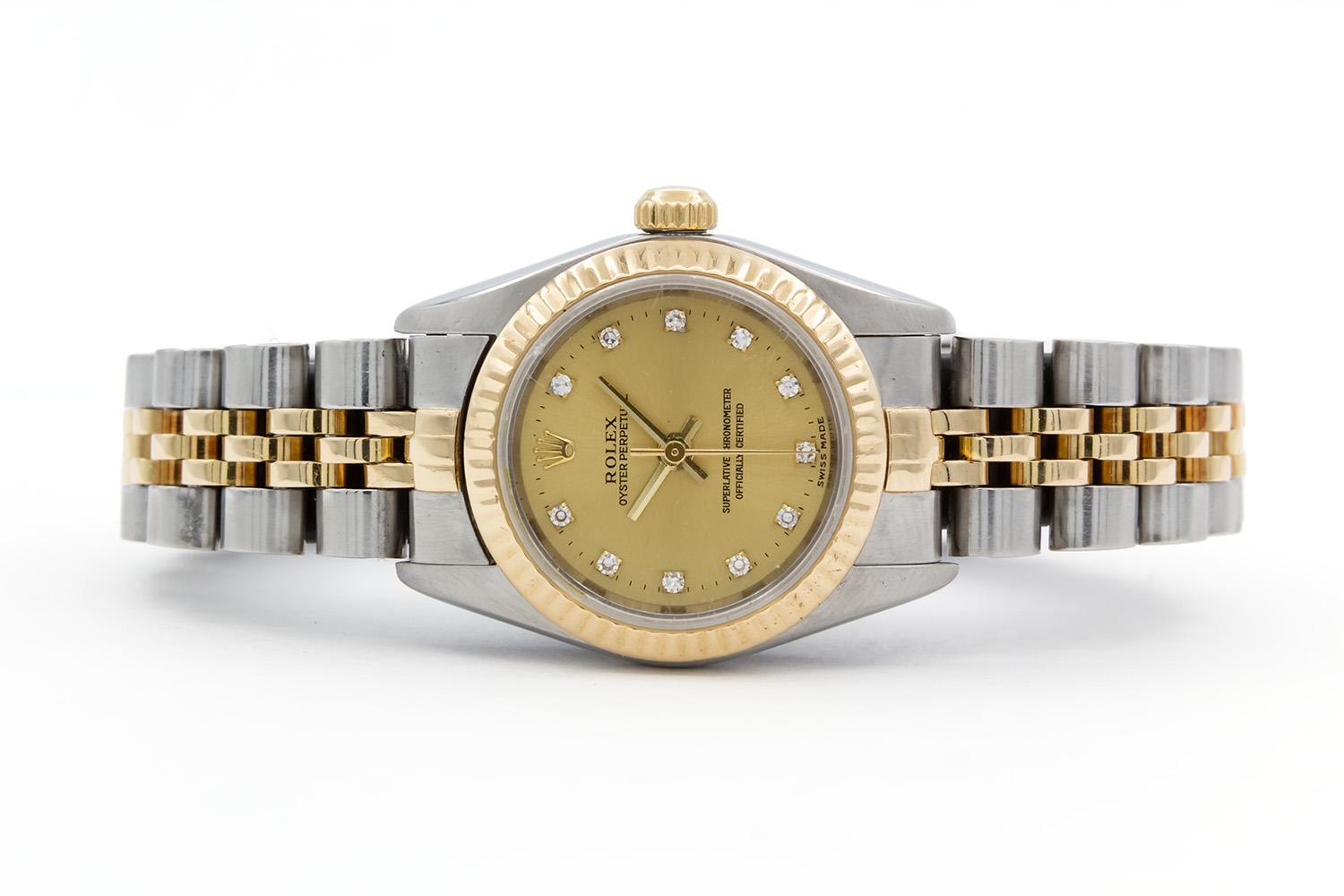 We are pleased to offer this 1999 Rolex Ladies Two Tone Oyster Perpetual 76193. This is a beautiful ladies watch, timeless in its design. It features a 24mm stainless steel case, 18k yellow gold fluted bezel, champagne diamond dial and two tone