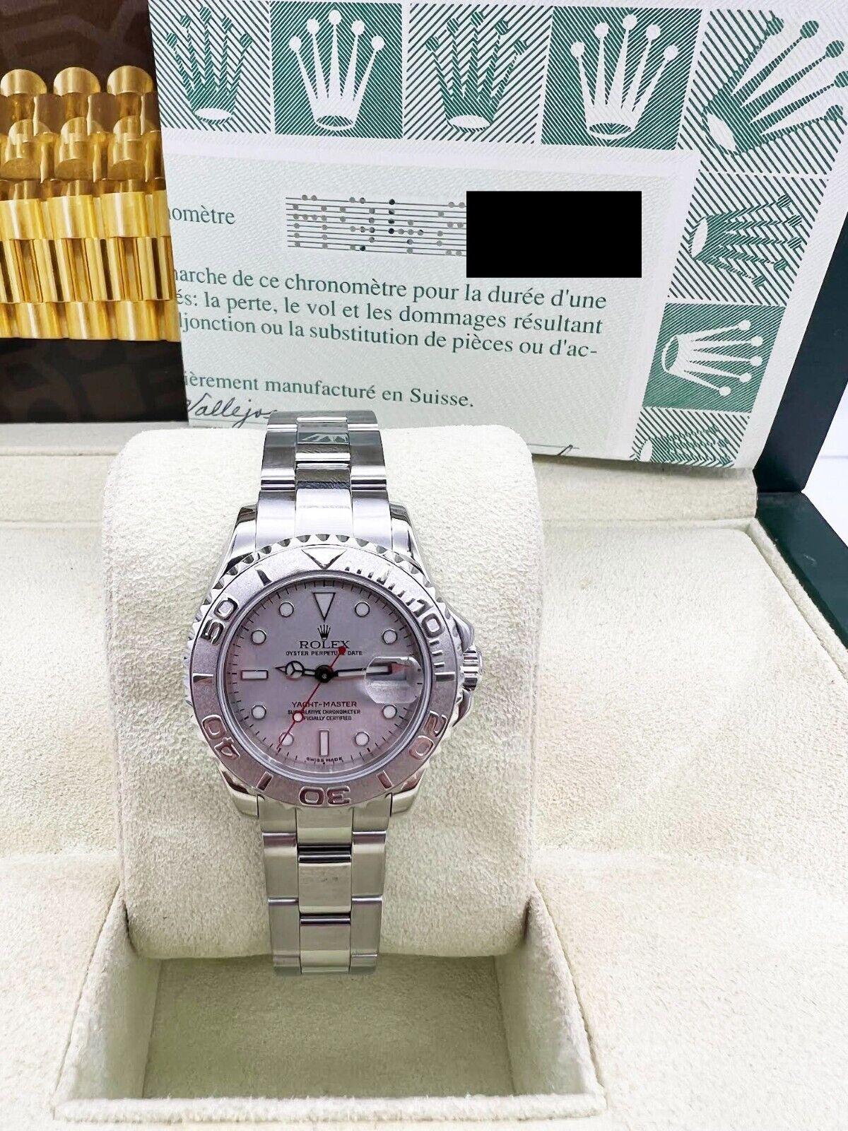 Style Number: 169622

Serial: A948***

Year: 2000 

Model: Ladies Yacht Master 

Case Material: Stainless Steel 

Band: Stainless Steel 

Bezel: Platinum 

Dial: Platinum 

Face: Sapphire Crystal

Case Size: 29mm

Includes: 

-Rolex Box &