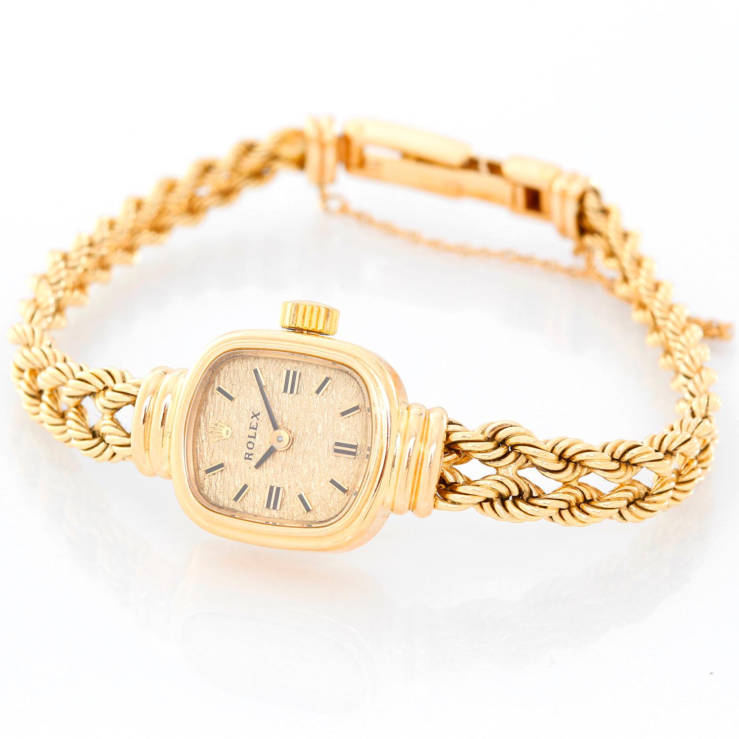 Rolex Ladies 14K Yellow Gold Classique Watch  - Manual winding . cushion shaped 14K Yellow gold ( 16 mm ) . Textured champagne dial with stick hour markers . 14K Yellow gold bracelet . Pre-owned with custom box .