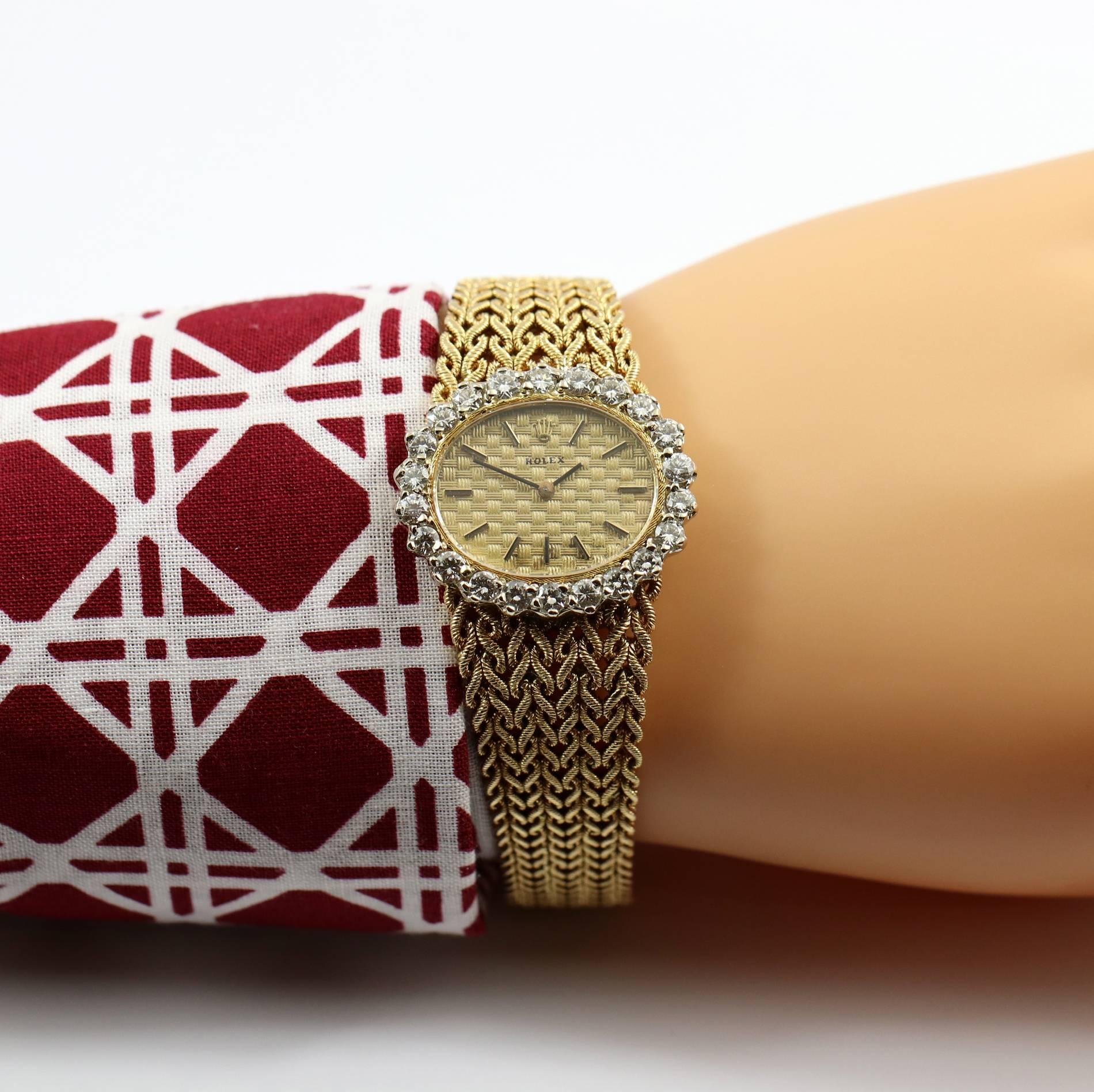 Ladies Rolex 18k yellow gold and diamond bracelet watch with manual-wind movement, quilted, champagne dial. The oval watch head has a diamond bezel set with 22 round brilliant-cut diamonds weighing an approximate total of 2.50cts of overall G color