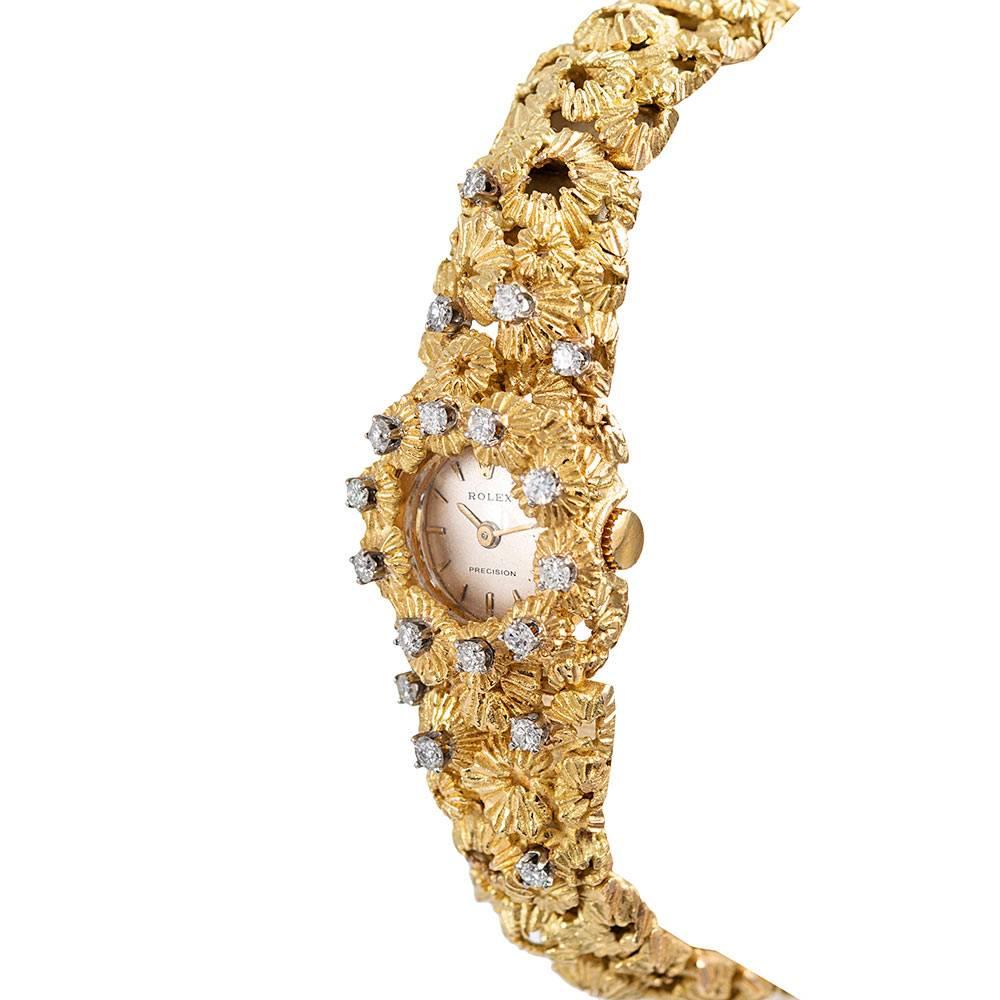 Unique and rare, this 1960s Rolex is hand made of 18 karat yellow gold and boasts a three-dimensional design that resembles sea urchins or barnacles. The bracelet incorporates seamlessly into the case, creating a gorgeous piece of jewelry that also