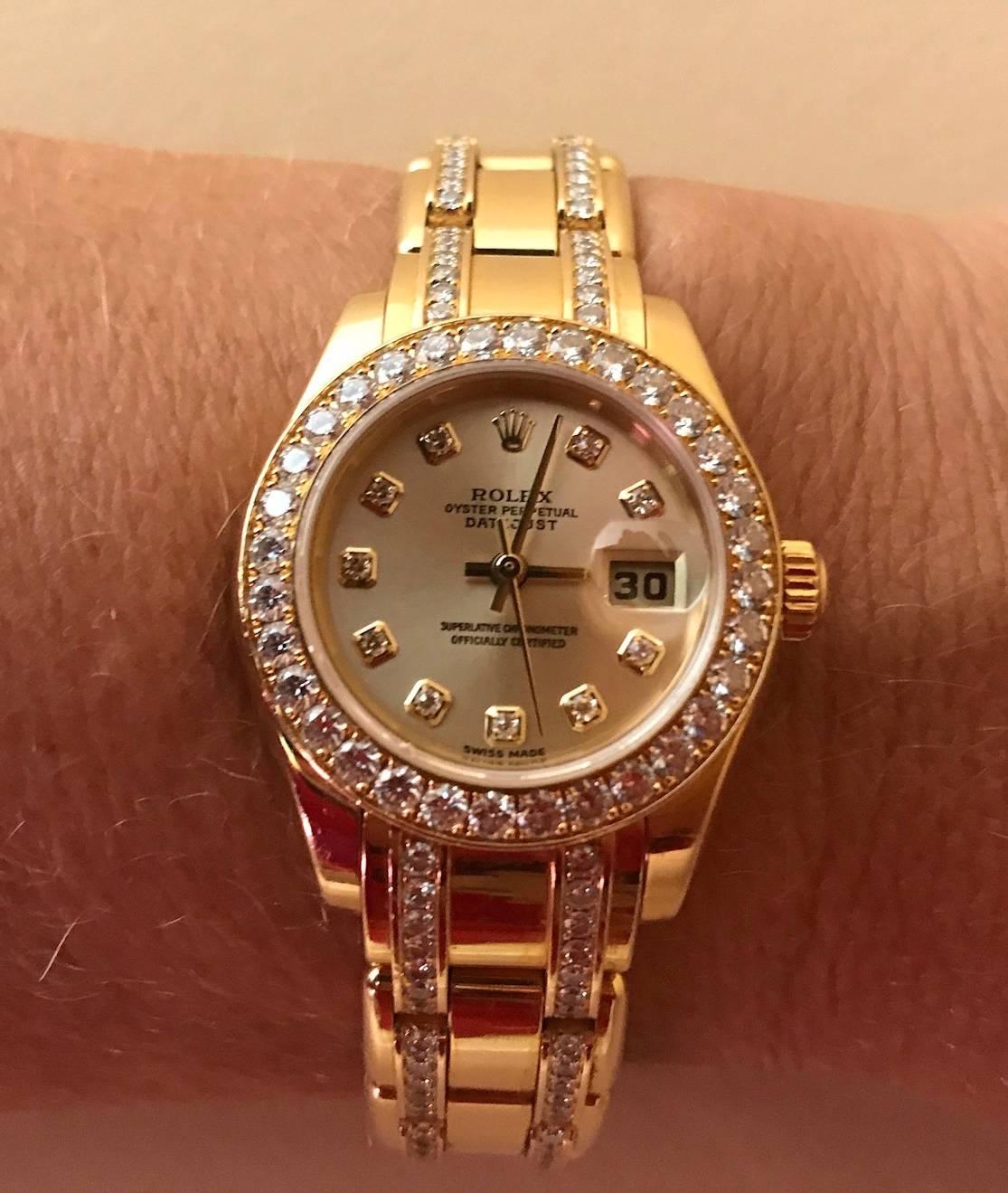 Lady's 18K yellow gold Rolex Oyster Perpetual Datejust Pearlmaster with champagne diamond dial, diamond bezel and diamond bracelet.
Style R8029882GB7494