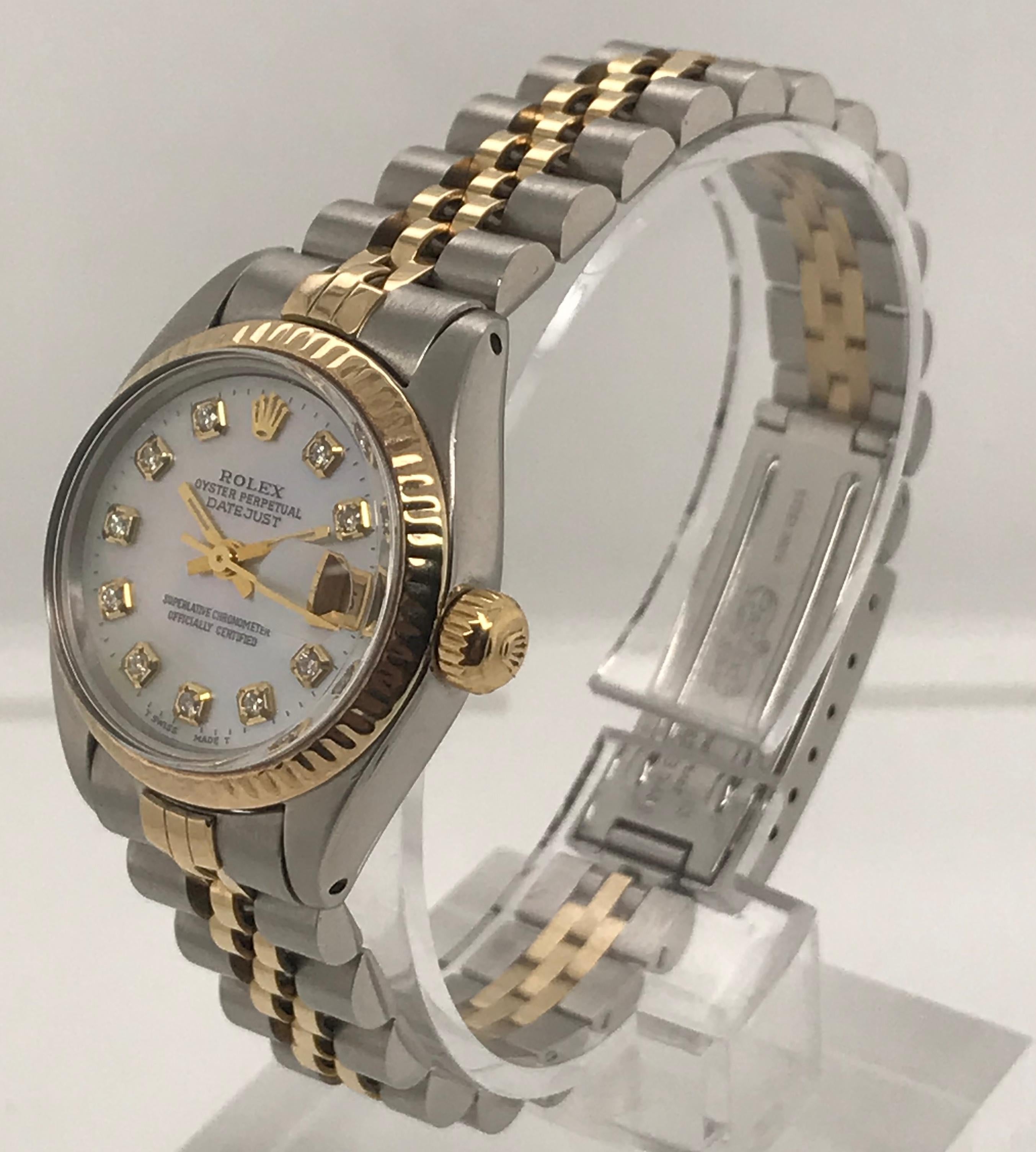 26mm Two Tone Ladies Rolex Datejust model with 18 karat yellow gold and Stainless Steel bracelet. Mother Pearl dial with Diamond accents. The bracelet is 18kt yellow gold and stainless steel with jubilee links.

Serial Number - 7*******

Model