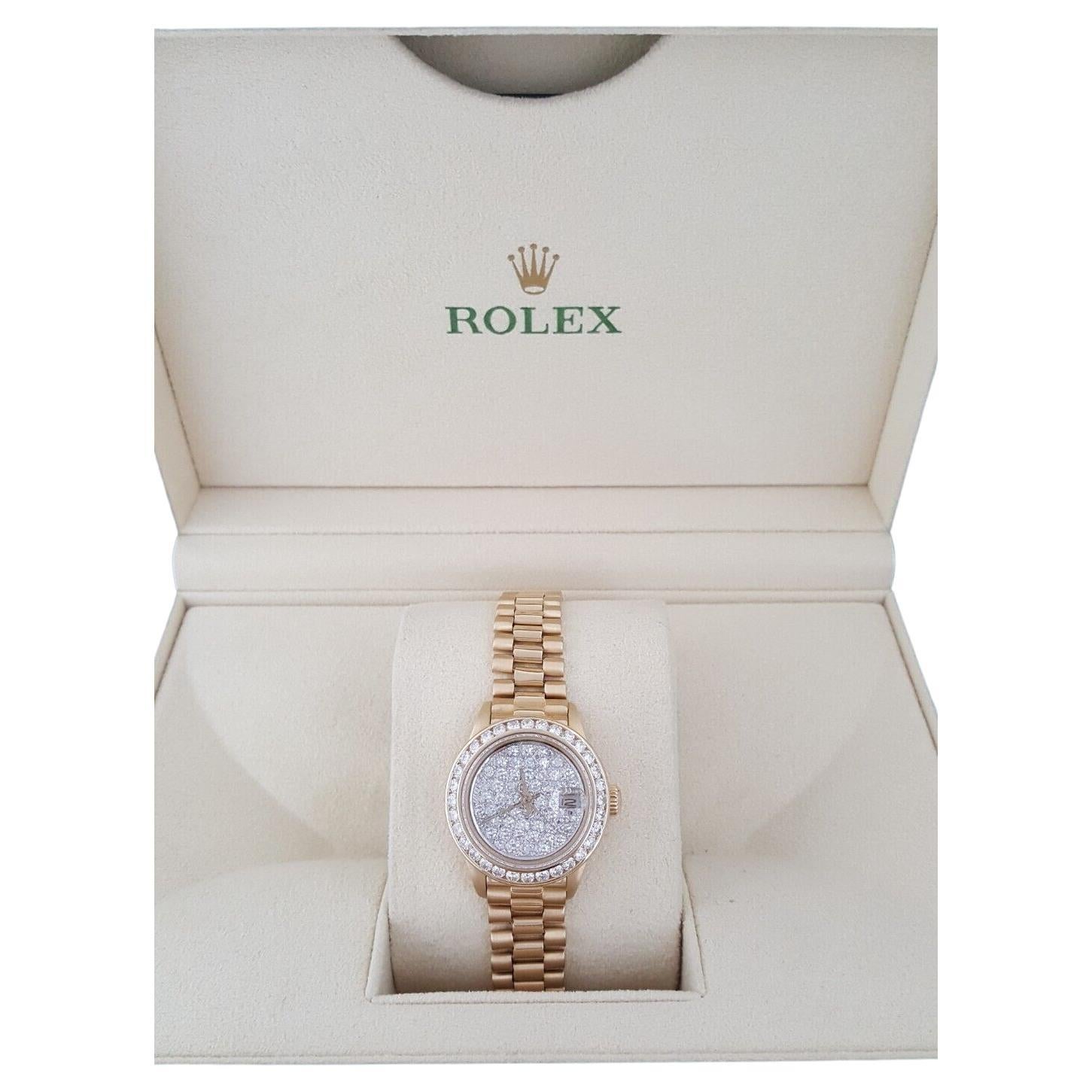 Authentic Rolex Lady Date-Just President 69178 18K Yellow Gold 26 mm Factory Diamond Dial & Bezel.

The watch features a screw-down crown 18K Yellow gold Factory diamond bezel, sapphire cyclops crystal, Champagne dial with 18k yellow gold & Factory